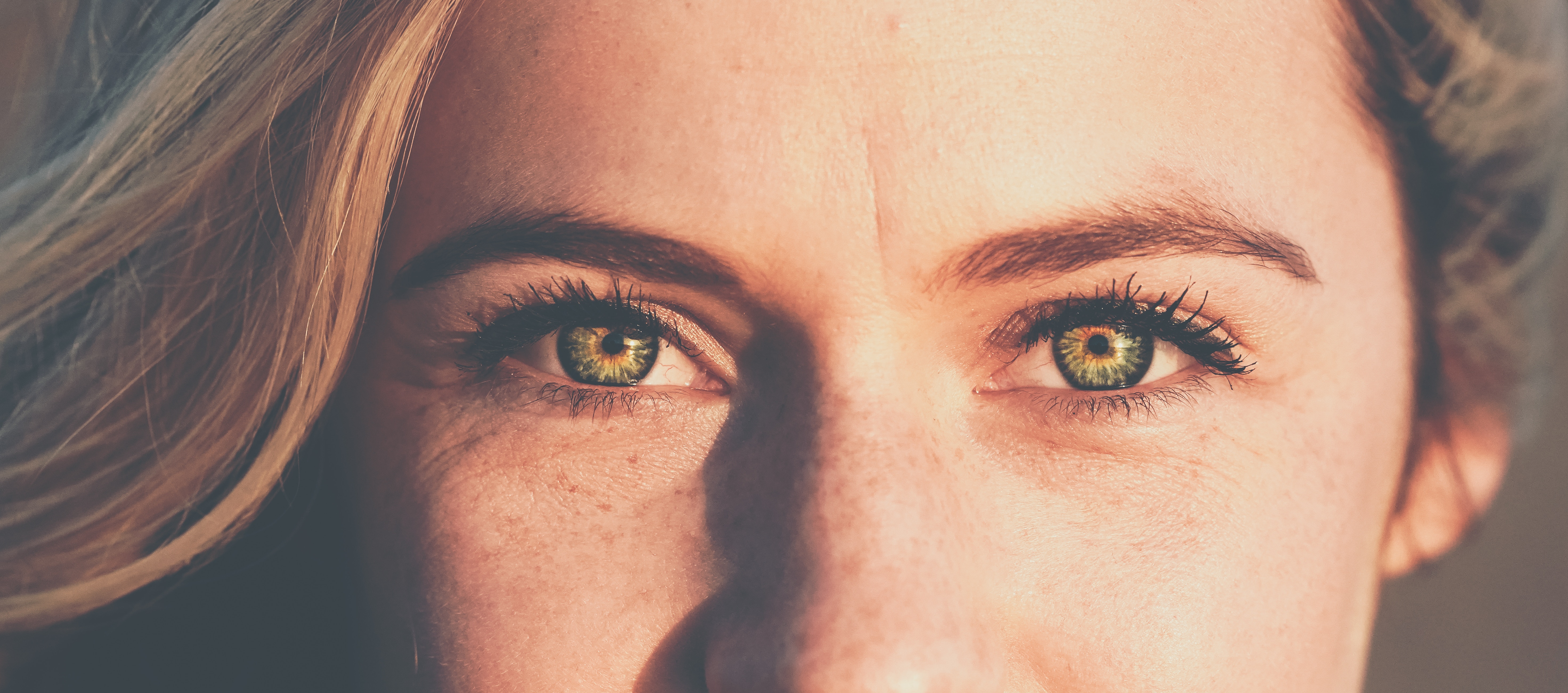 Close-up of a woman's green eyes with freckles HD Wallpaper
