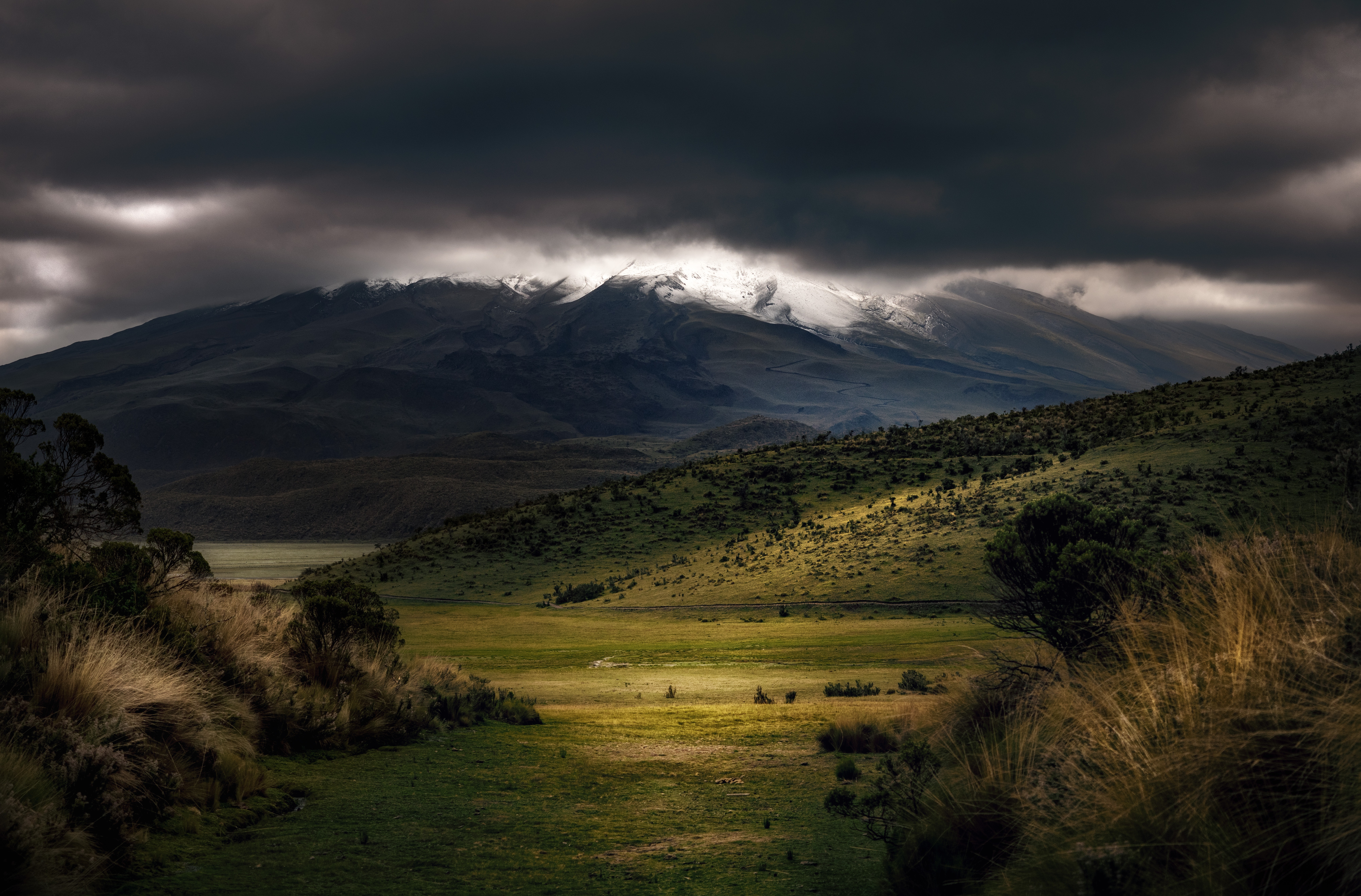 Mighty mountain with snow under dark clouds in Ecuador HD Wallpaper
