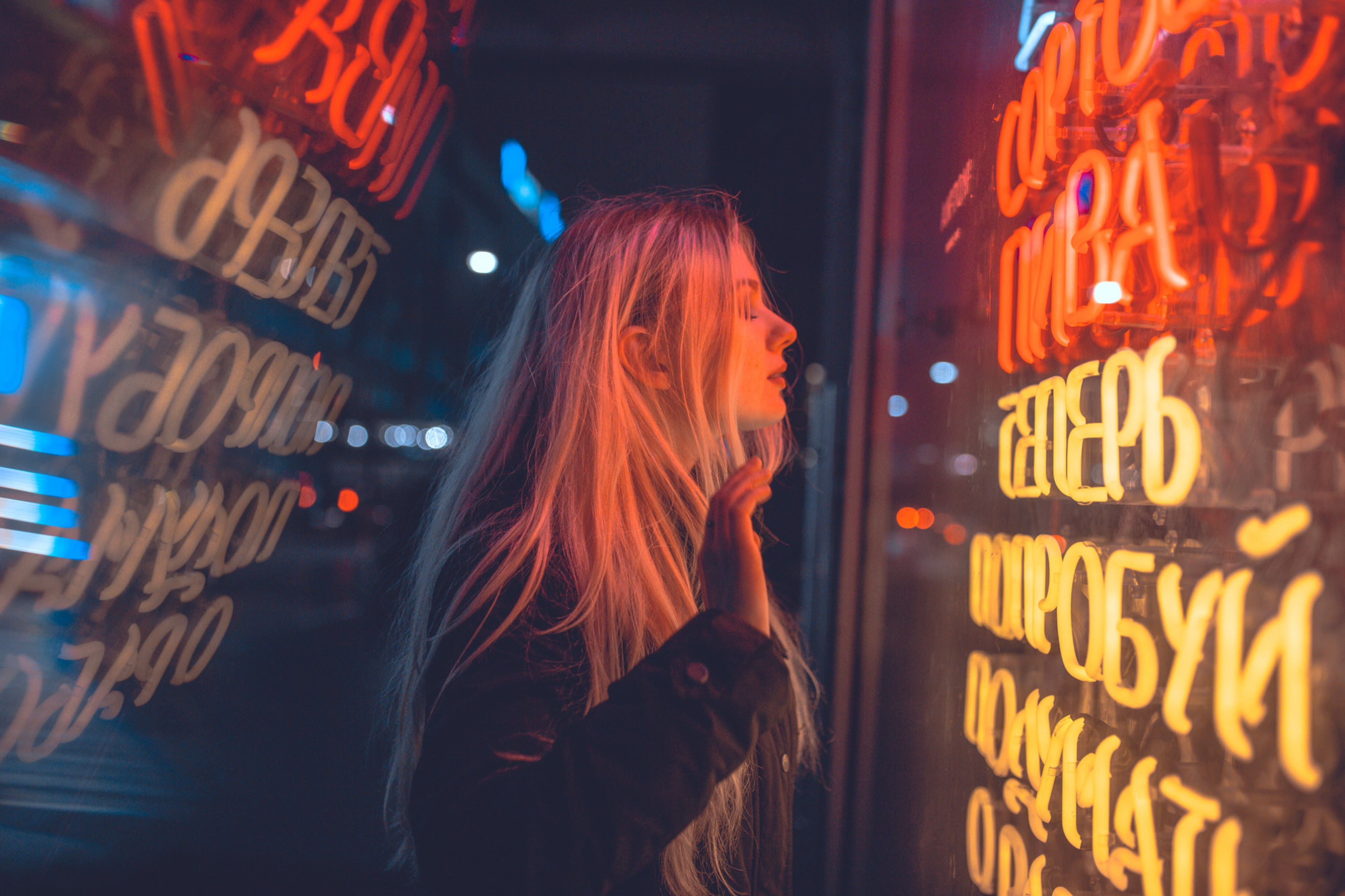 Woman looking at neon signs at night HD Wallpaper