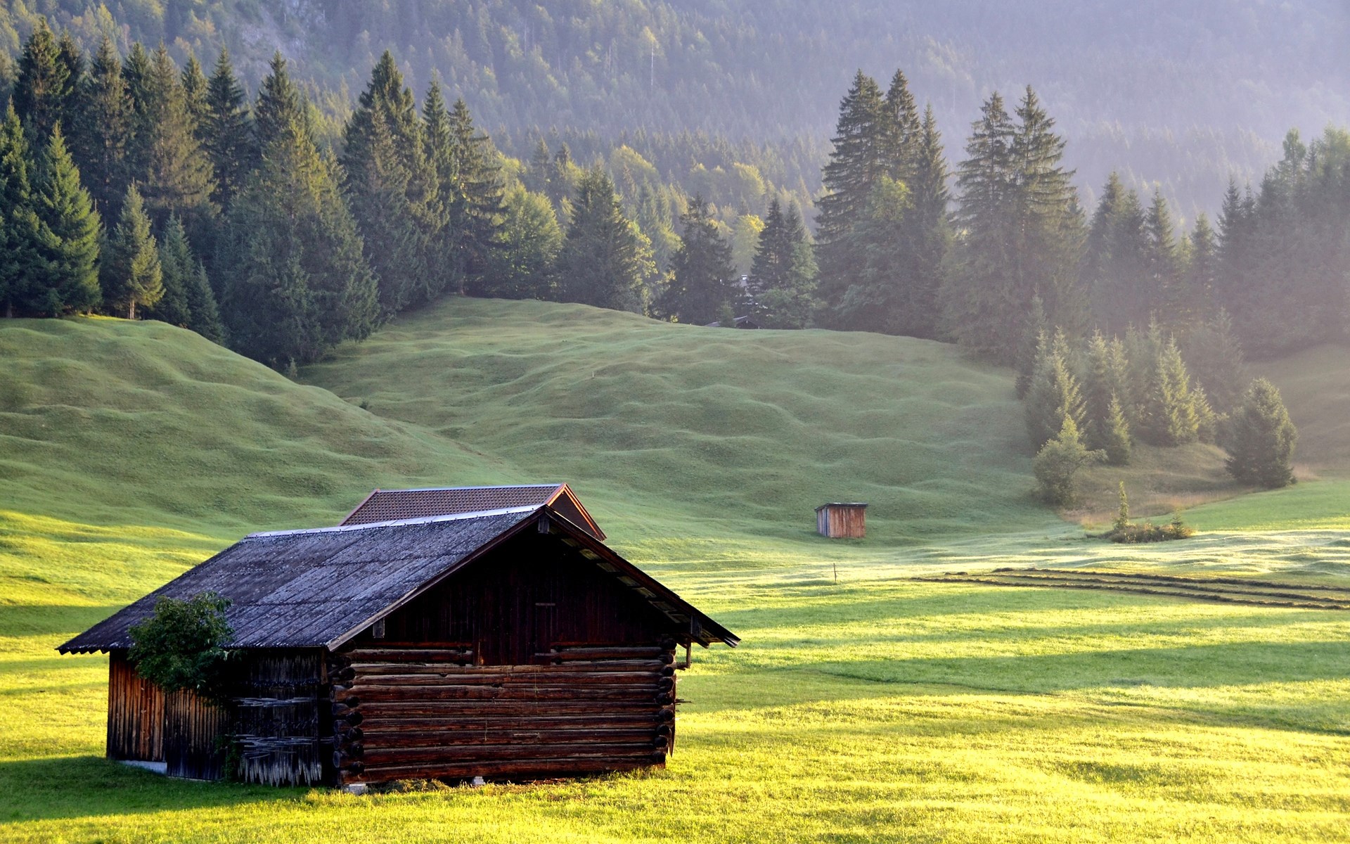 Wooden cabin in a green mountain meadow at sunrise HD Wallpaper