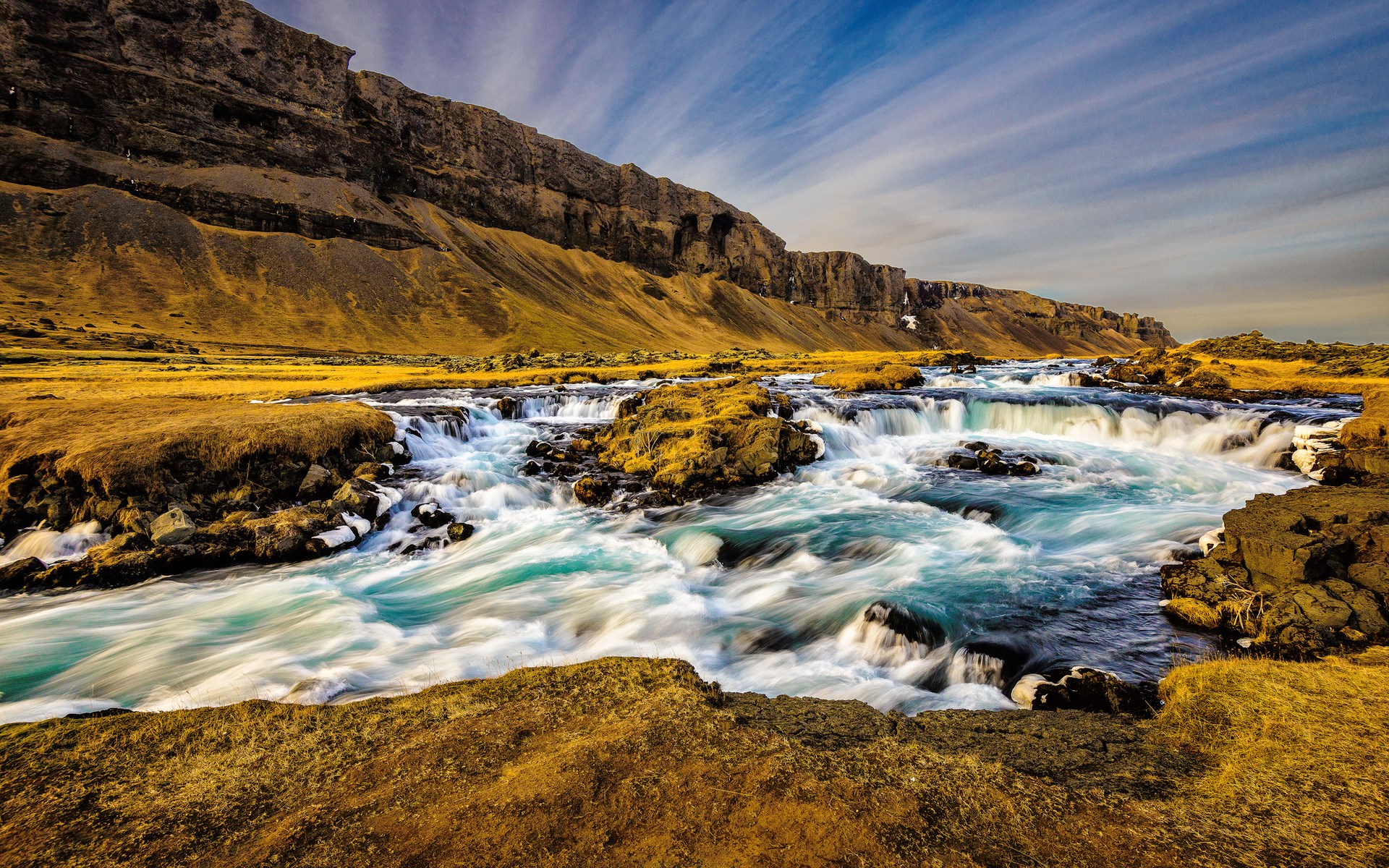 River flowing through a rocky landscape with mountains HD Wallpaper