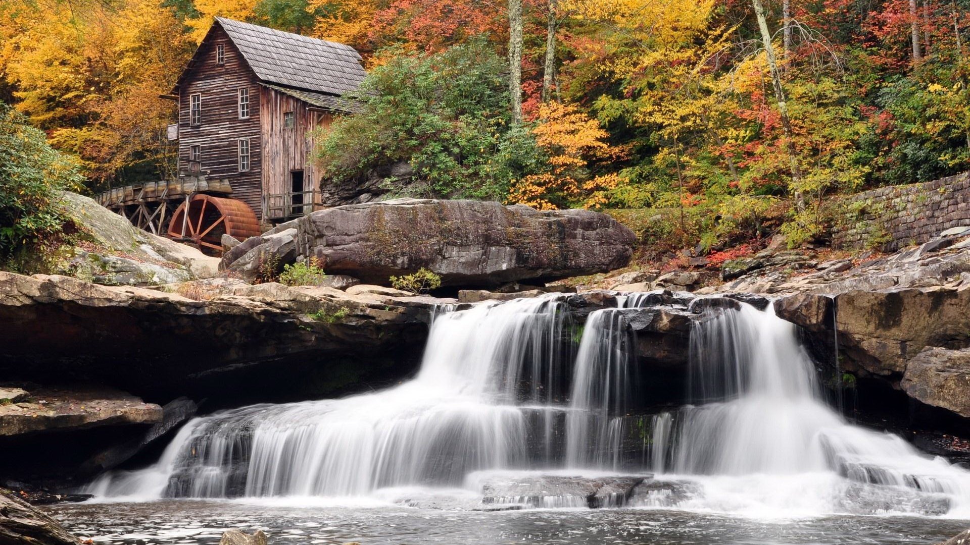 Old mill with a water wheel beside a waterfall in autumn HD Wallpaper