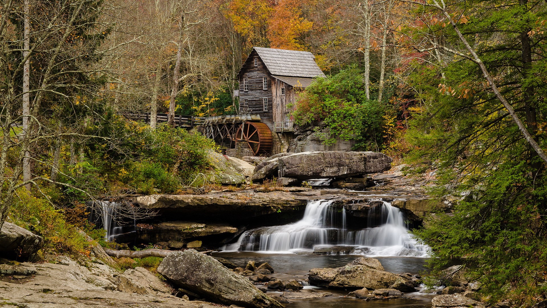 Old wooden mill with water wheel by waterfall in autumn forest HD Wallpaper
