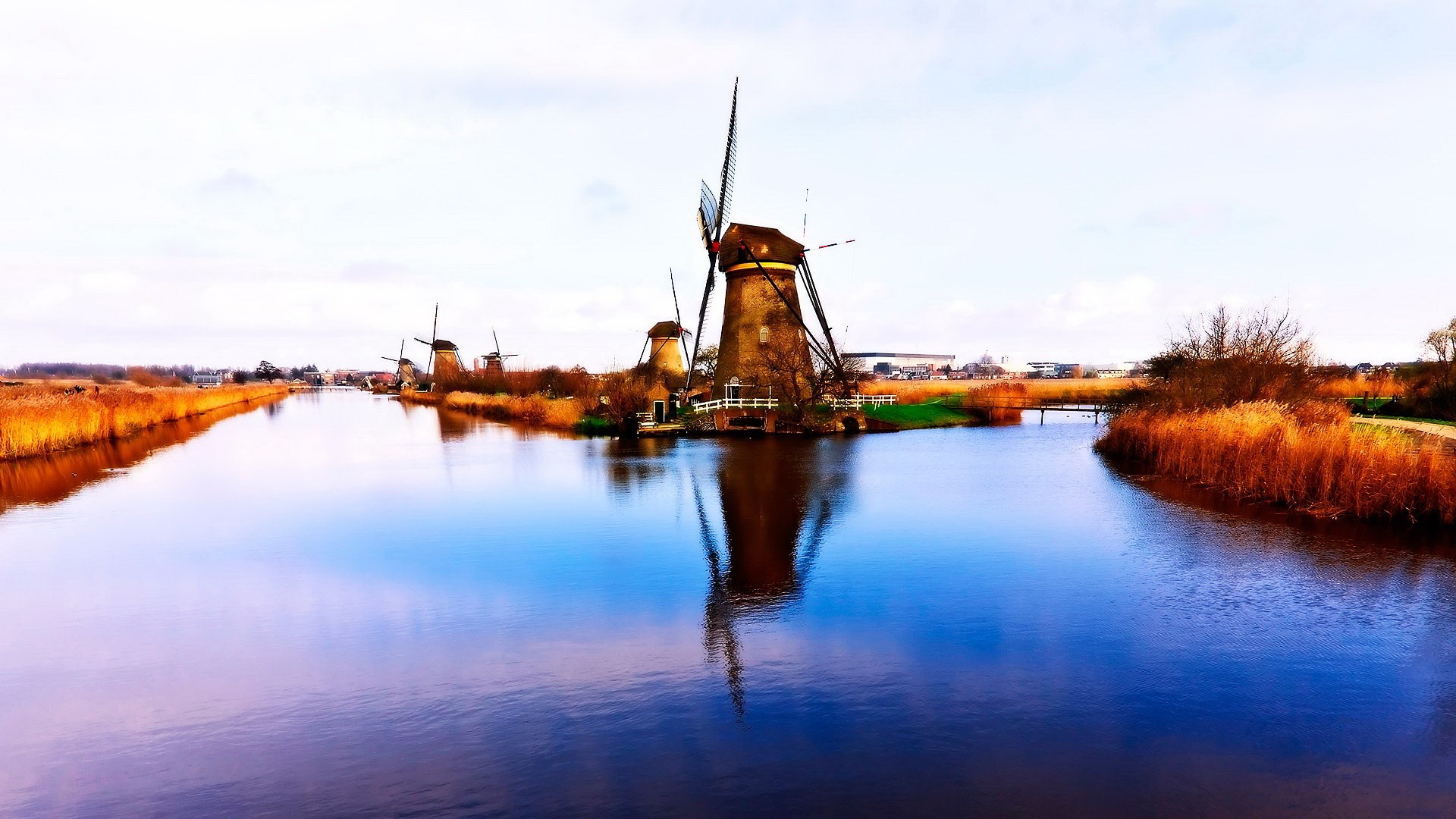 Windmills reflected in a canal in Kinderdijk HD Wallpaper