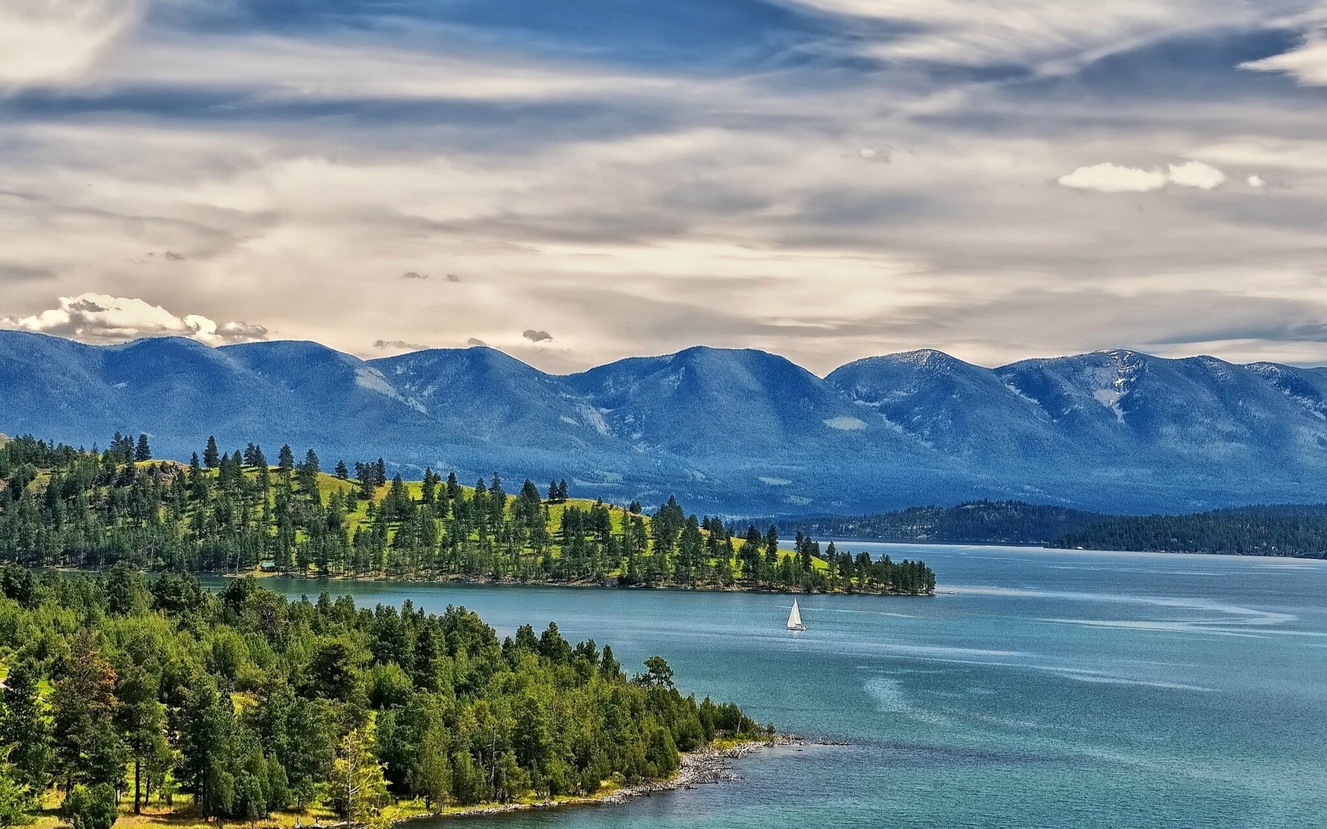 Sailboat on a lake with mountains and forest HD Wallpaper