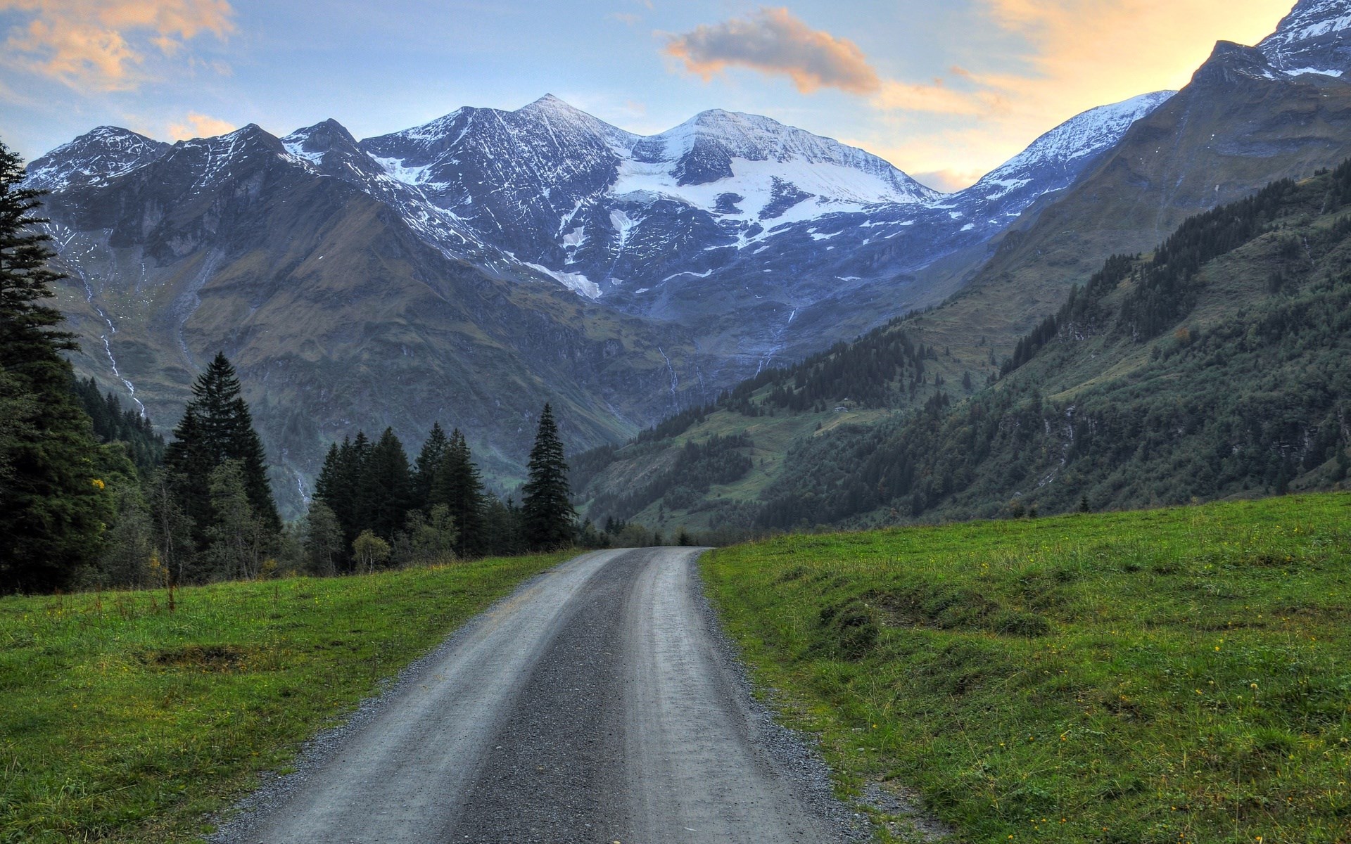 Gravel road leading to snow-capped mountains HD Wallpaper