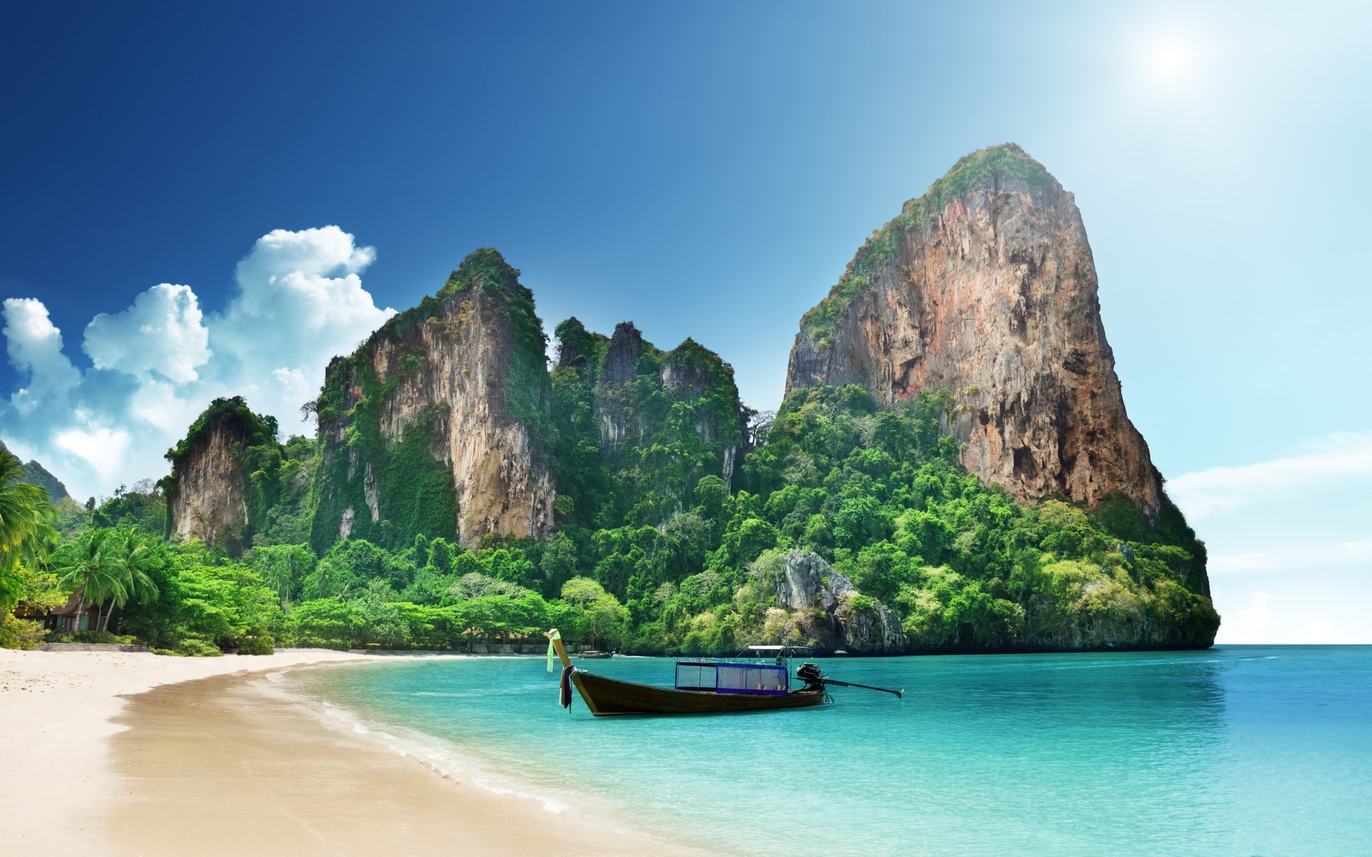 Tropical beach with limestone cliffs and a boat HD Wallpaper