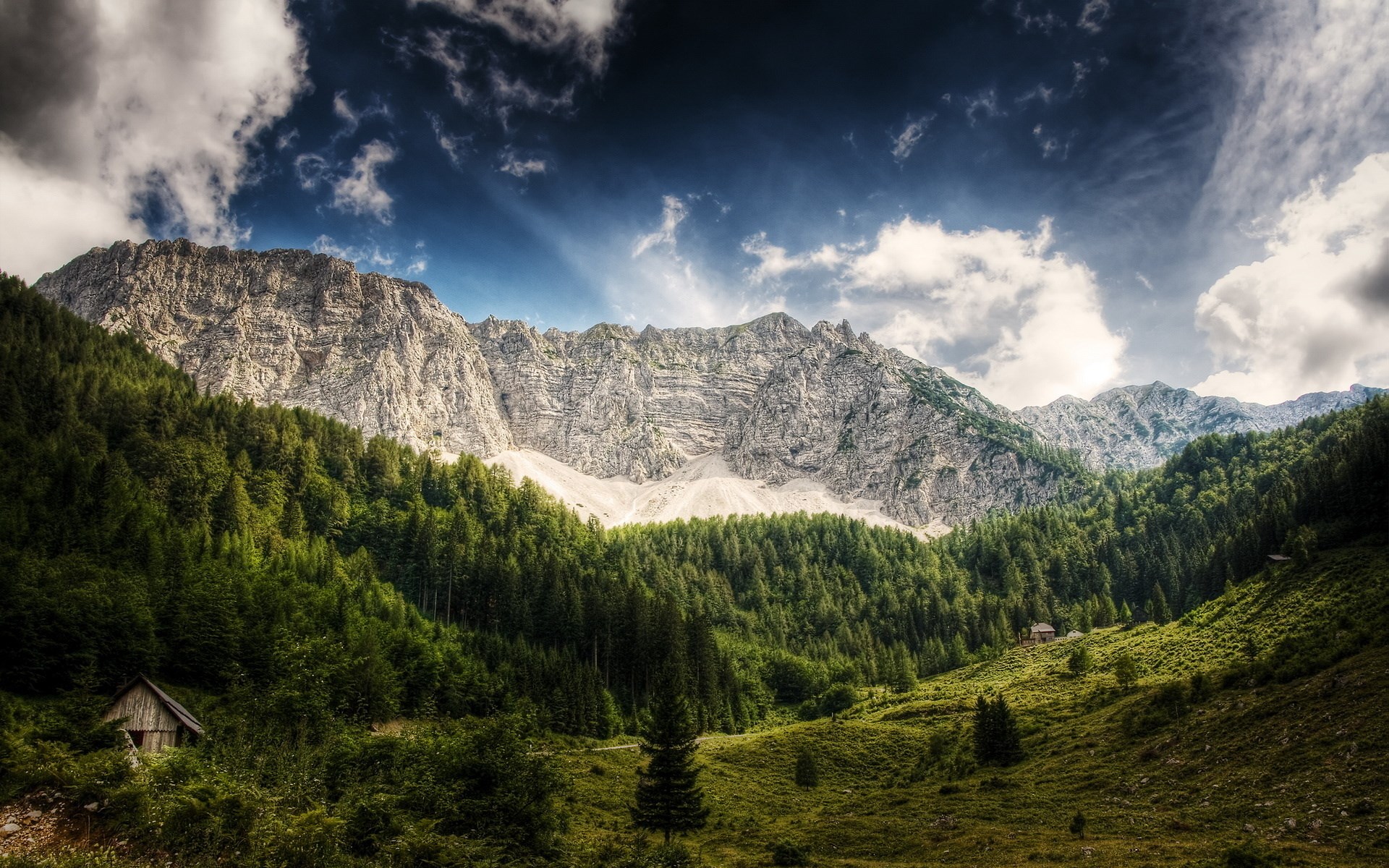 Mountain range with forest and a small cabin HD Wallpaper