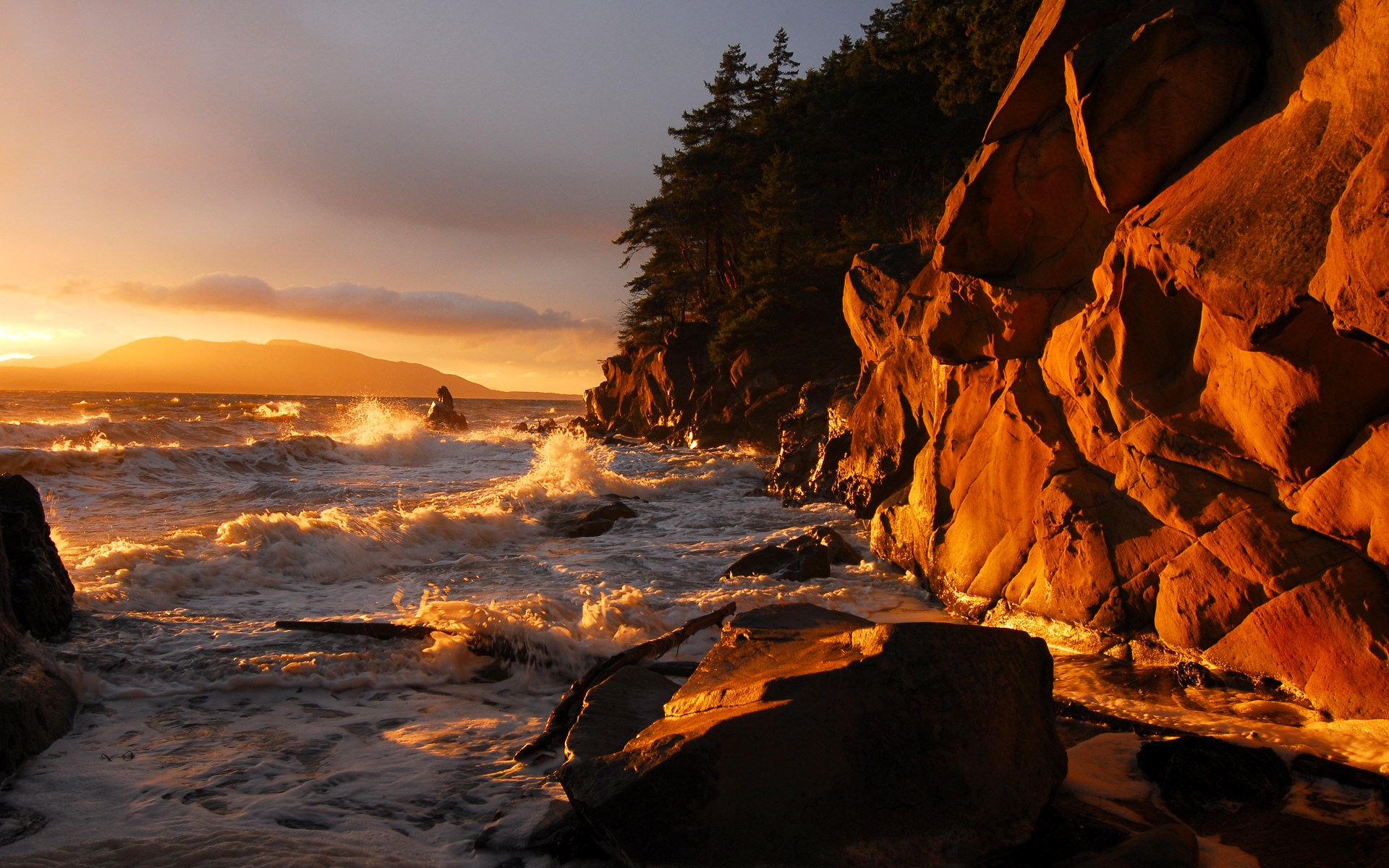 Waves crashing on rocky shore at sunset HD Wallpaper