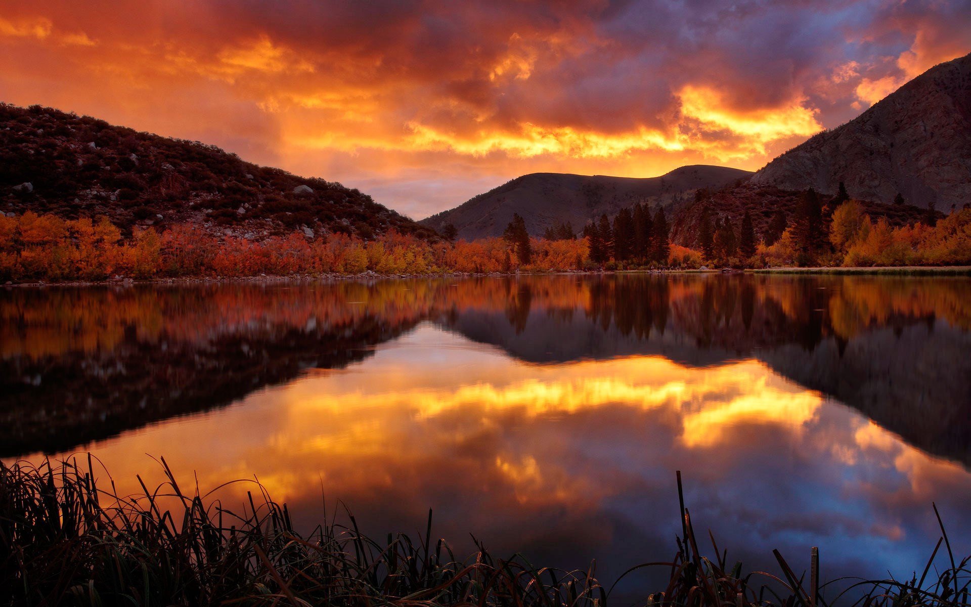 Sunset over a lake with autumn trees and mountains HD Wallpaper