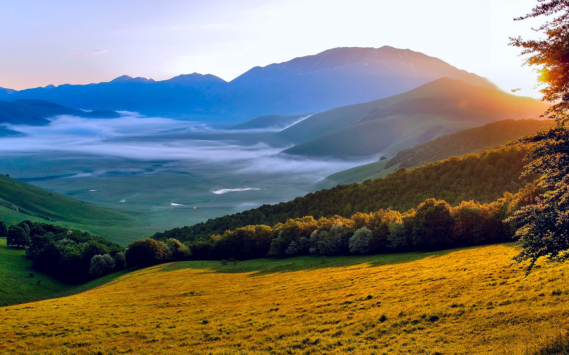 Sunrise over misty mountains and green valleys HD Wallpaper