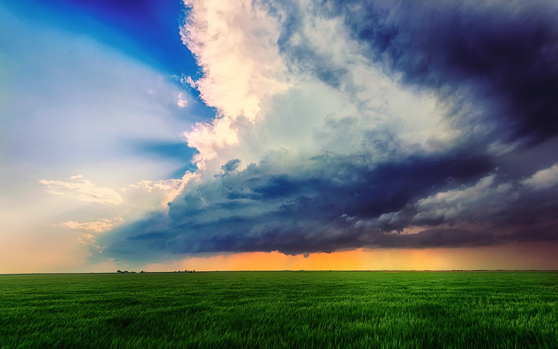 Stormy clouds over a green field HD Wallpaper