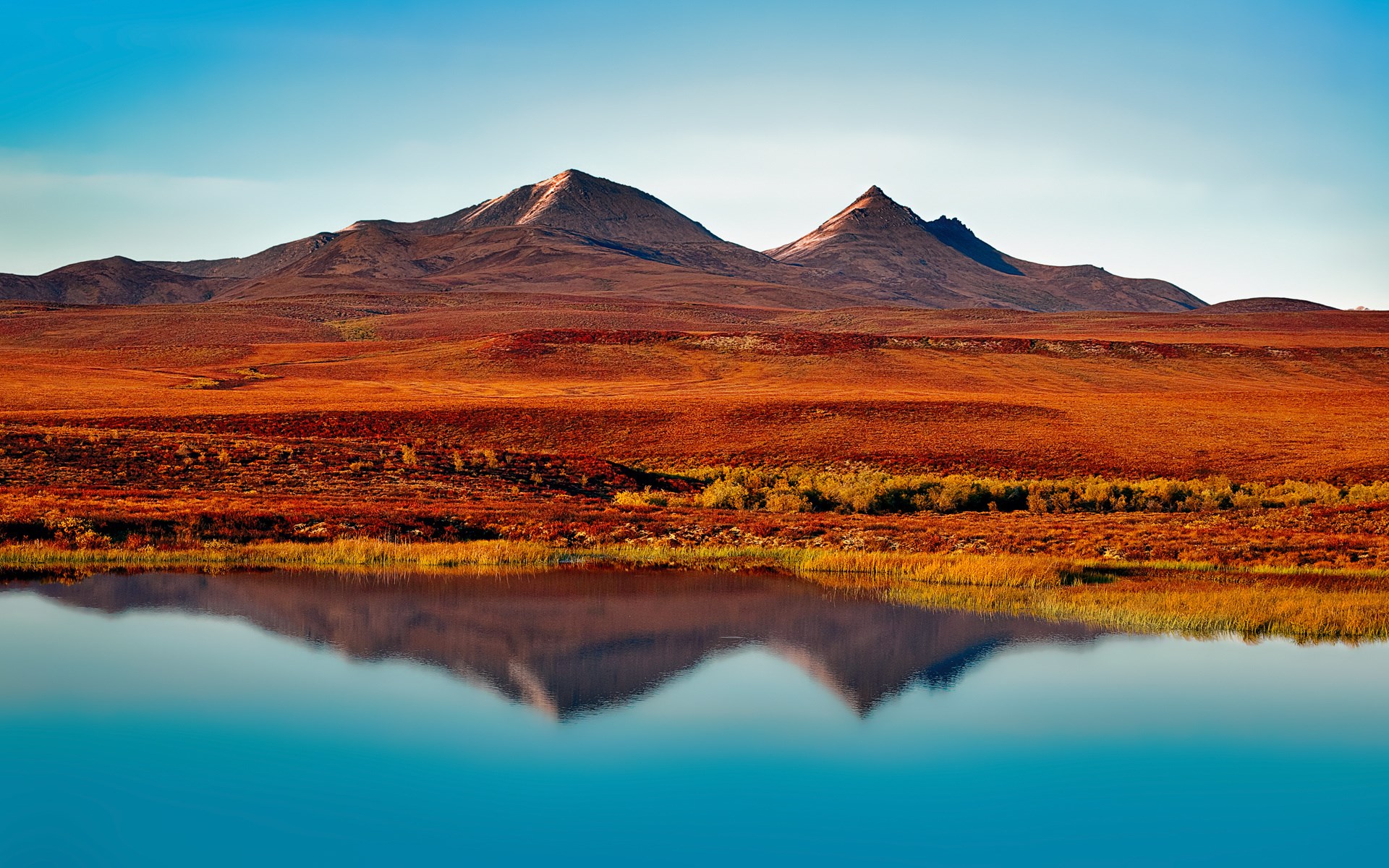 Mountains reflected in a lake with orange tundra HD Wallpaper