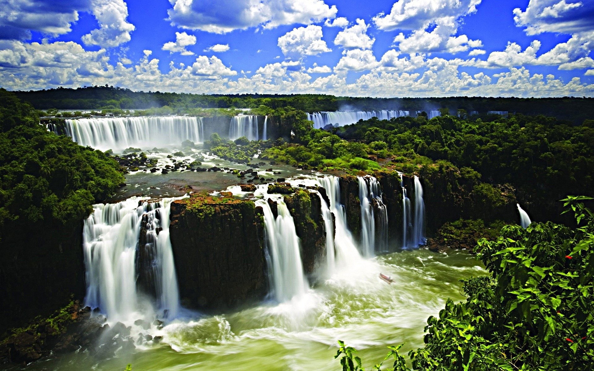 Iguazu Falls with a boat in the water HD Wallpaper