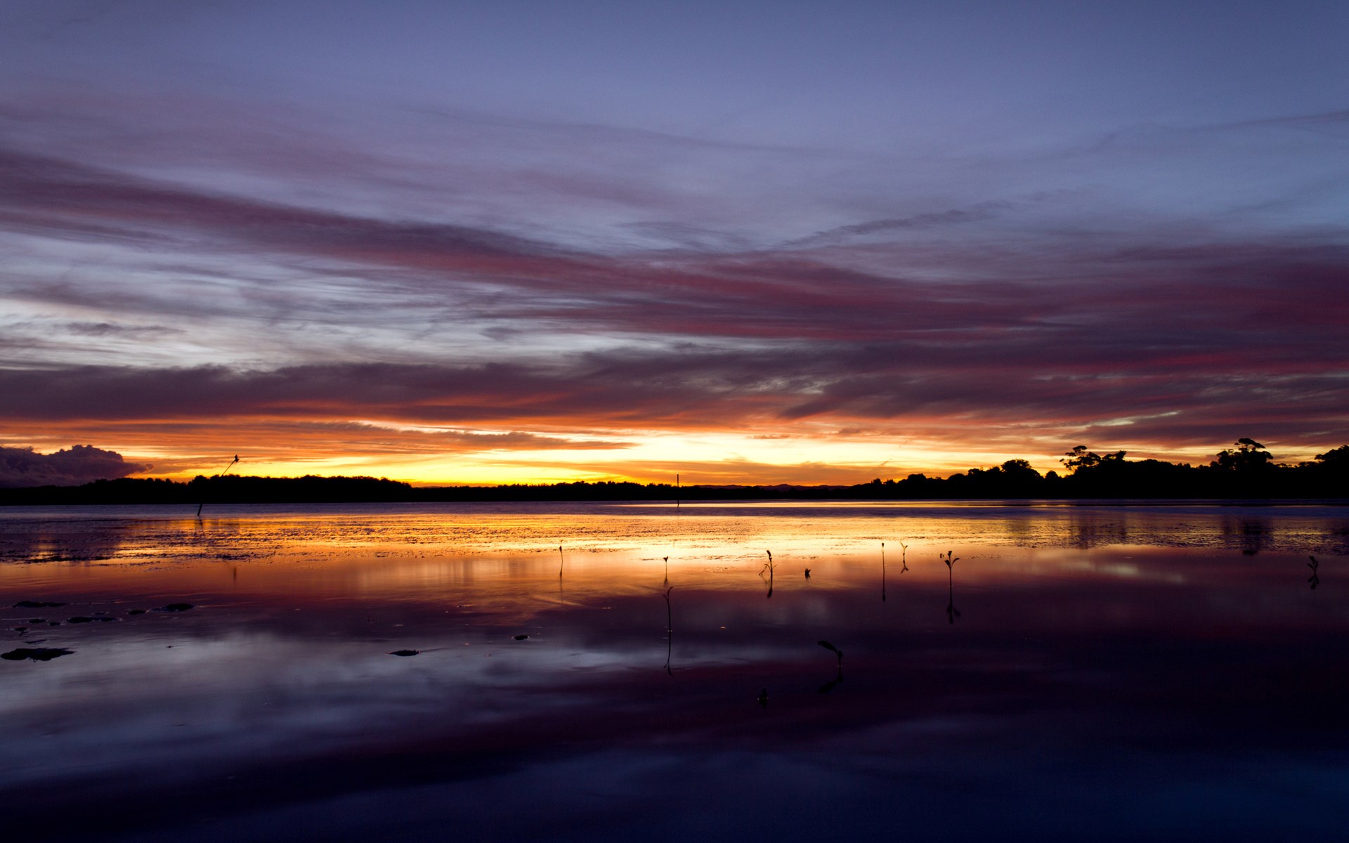 Sunset over a lake with colorful clouds and reflections HD Wallpaper