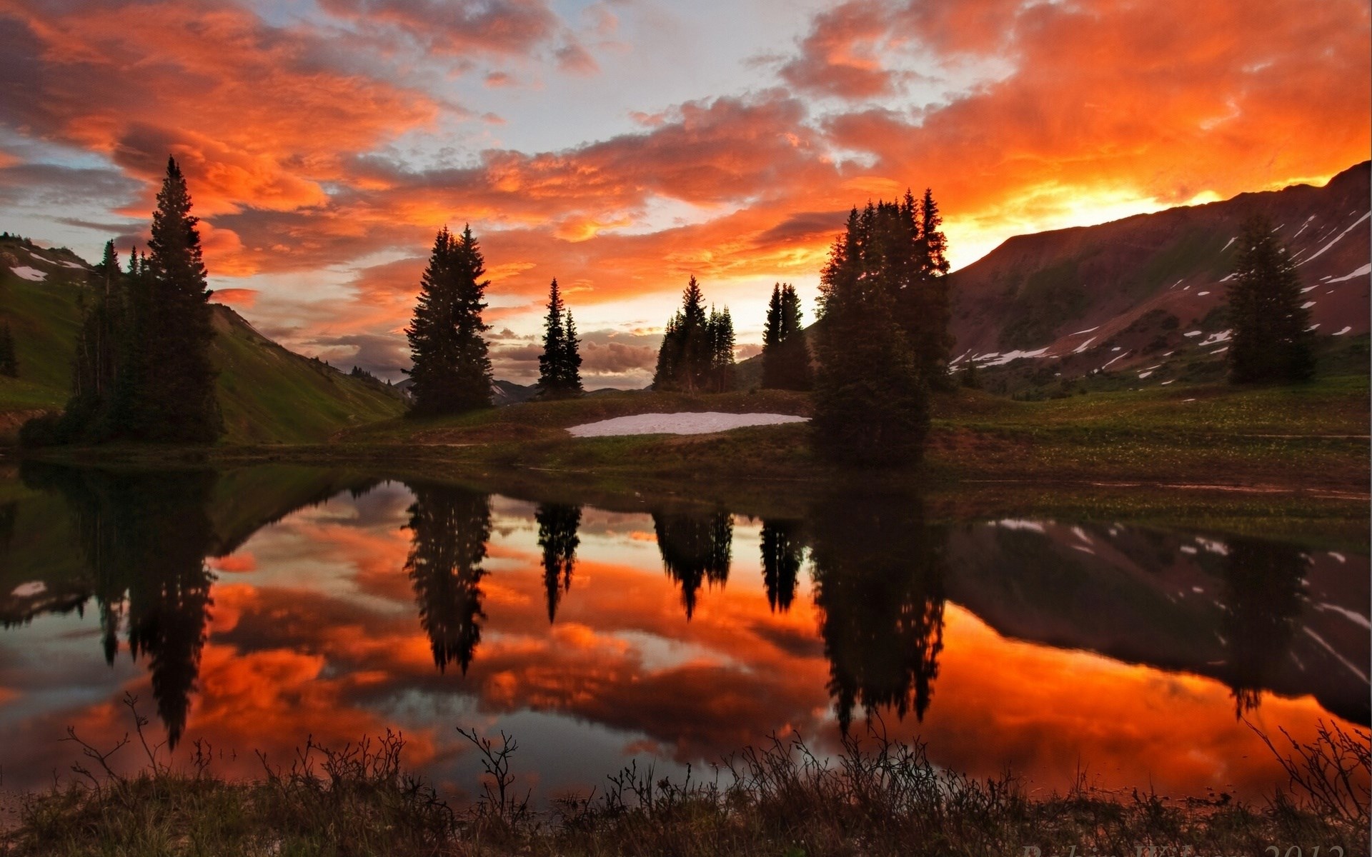Sunset over a mountain lake with reflections HD Wallpaper