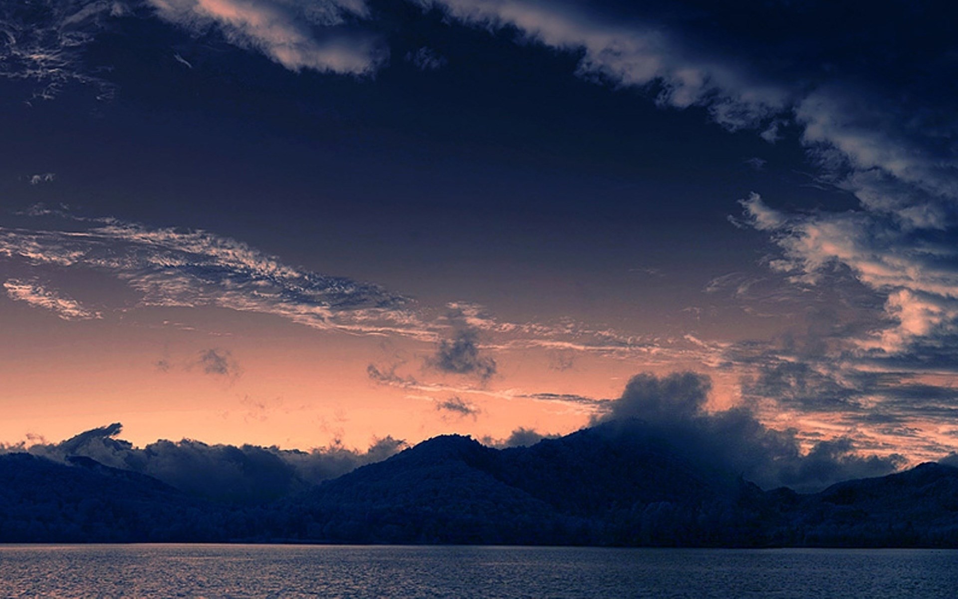 Dark mountains and clouds over a lake at dusk HD Wallpaper