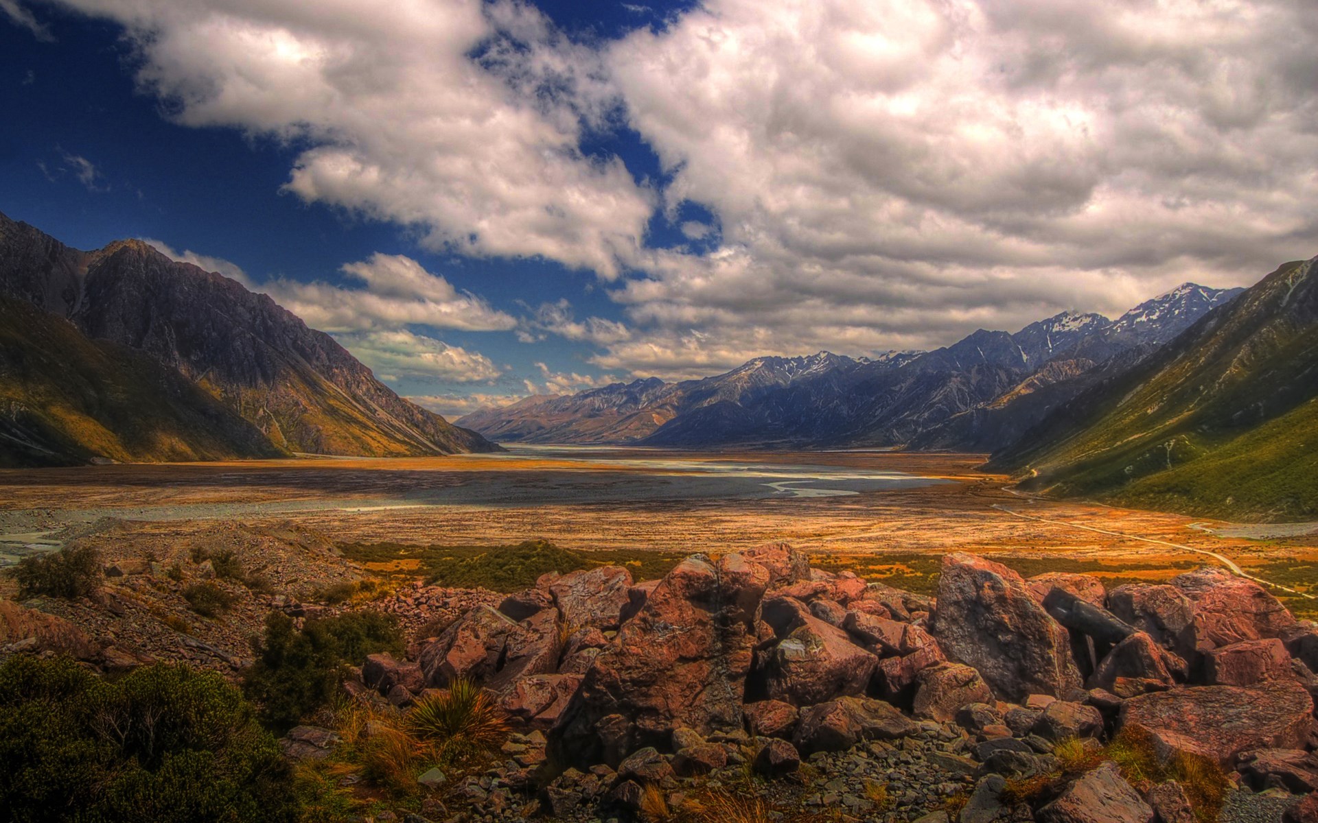 Valley with mountains and rocky foreground HD Wallpaper