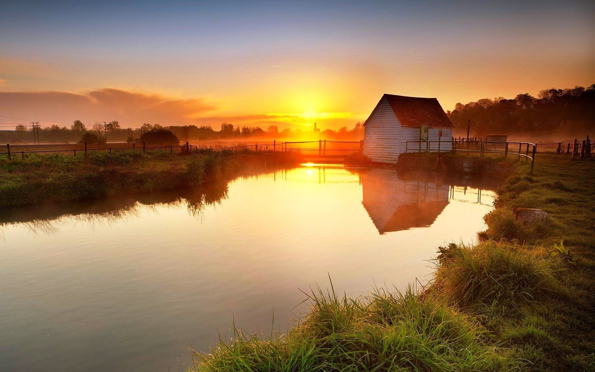White building by a river at sunset HD Wallpaper