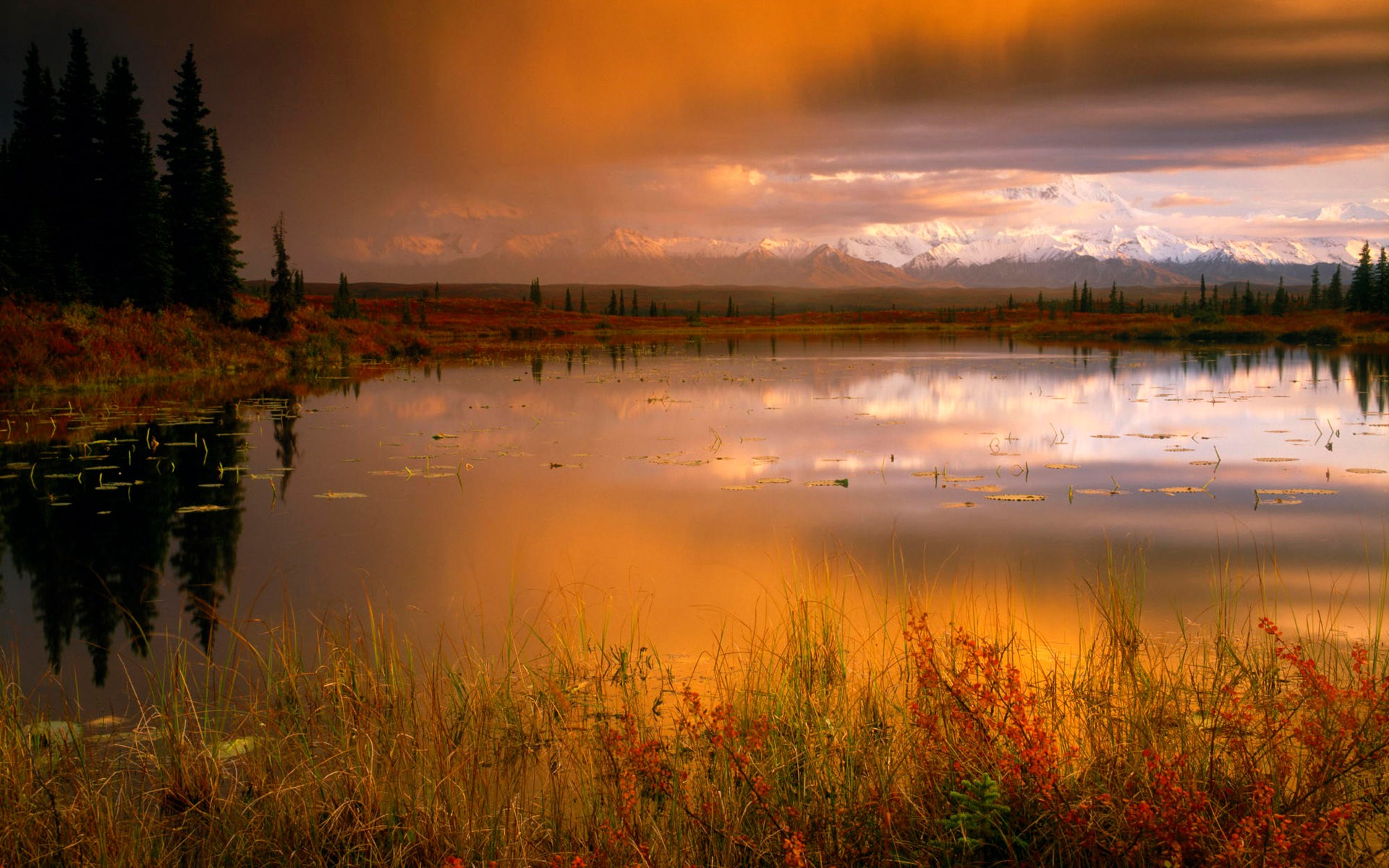 Lake reflecting snow-capped mountains at sunset HD Wallpaper