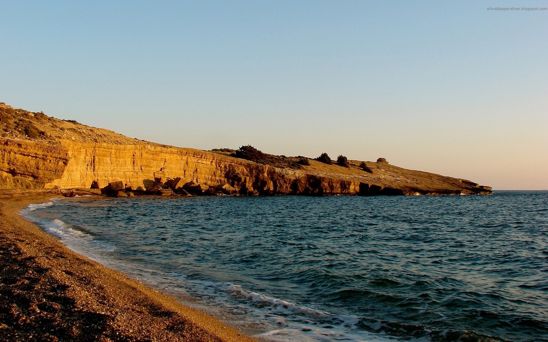 Coastal cliffs and beach at sunset HD Wallpaper