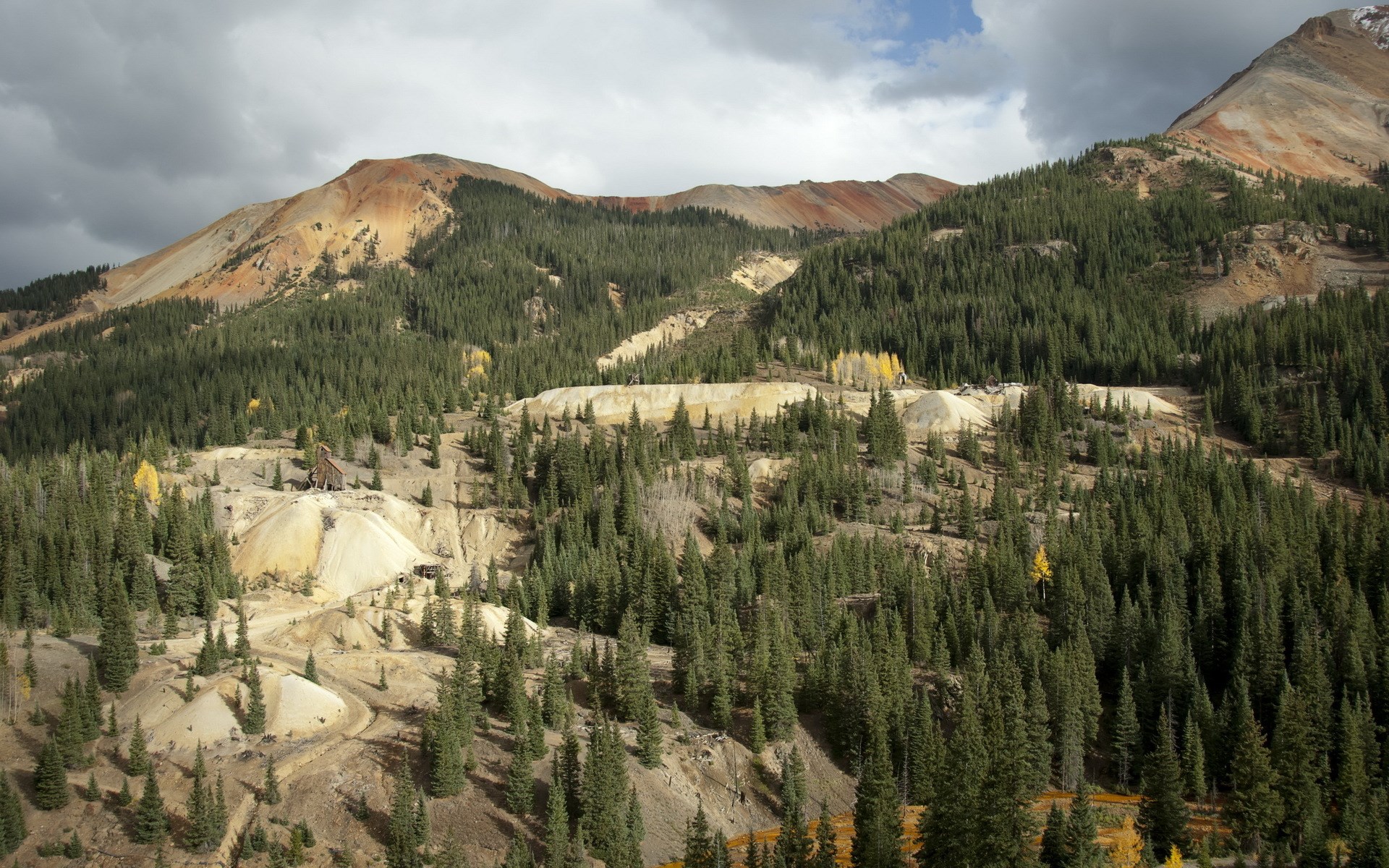 Mountain landscape with abandoned mine and evergreen forest HD Wallpaper