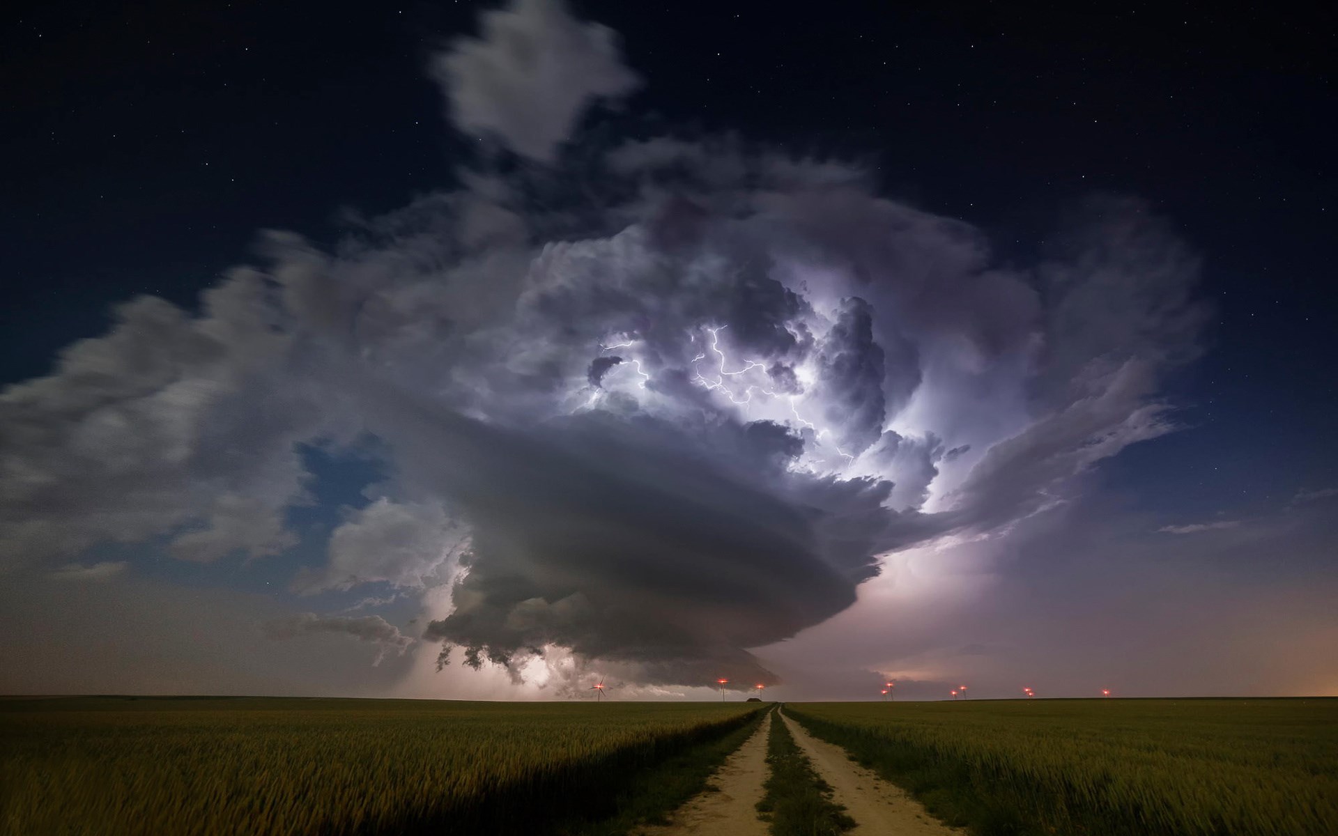 Lightning storm over a field at night HD Wallpaper