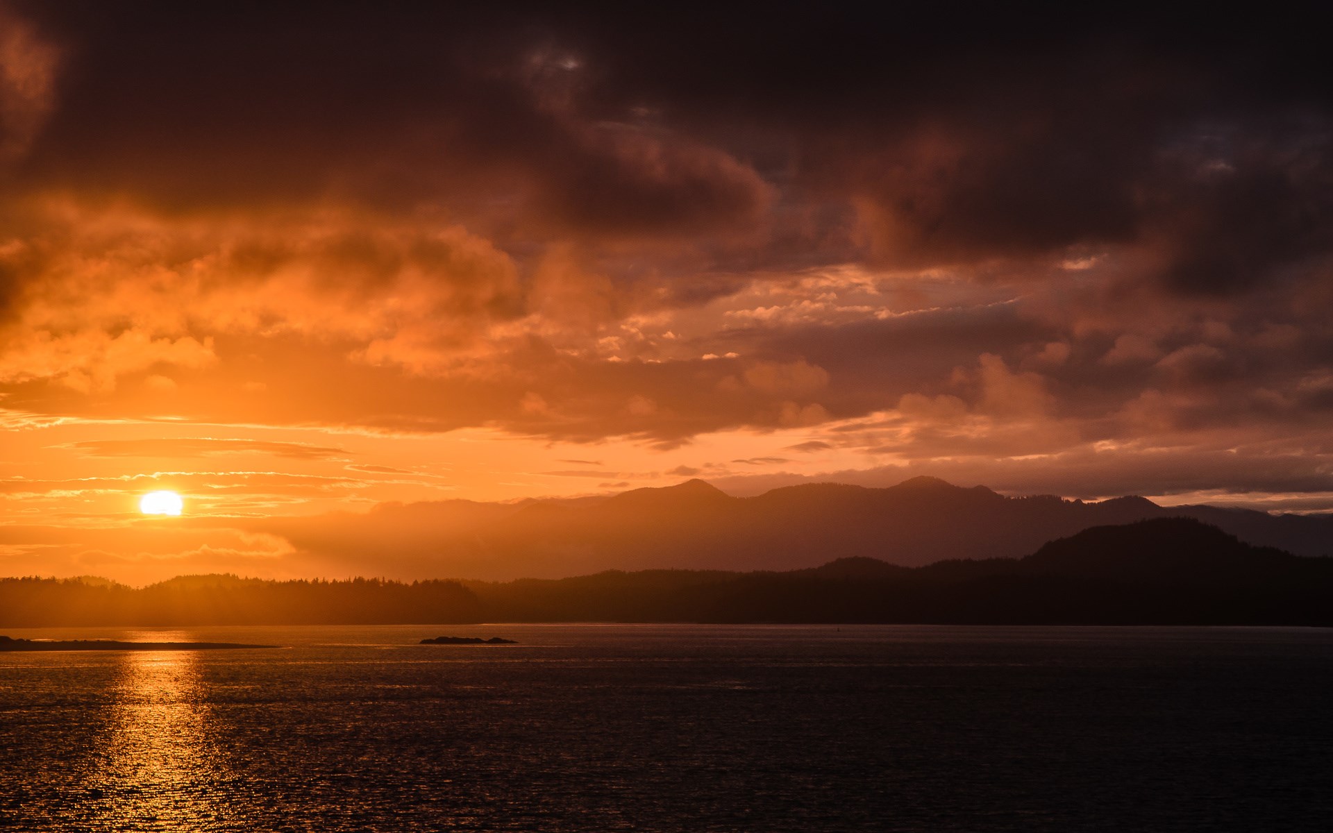 Sunset over mountains and ocean HD Wallpaper