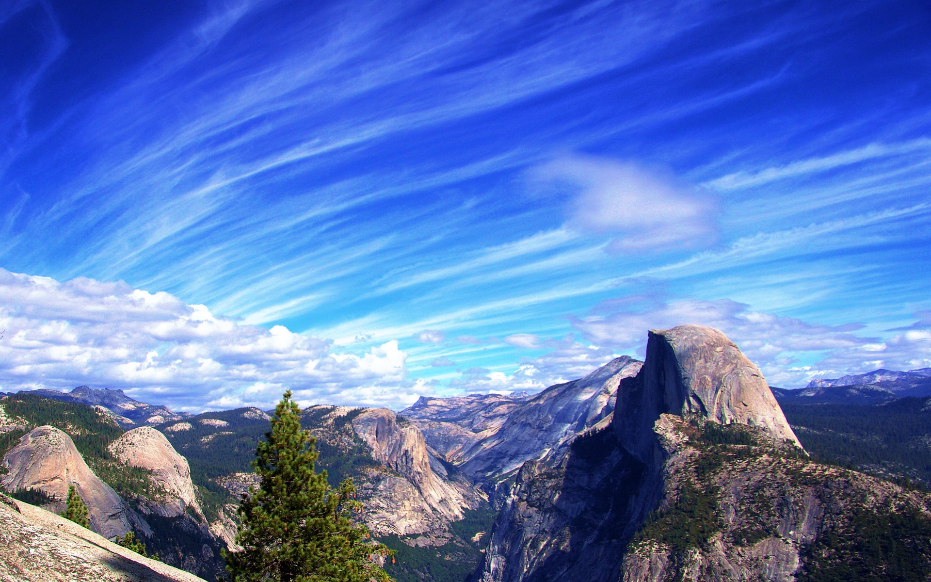 Half Dome and Yosemite Valley under a dramatic sky HD Wallpaper