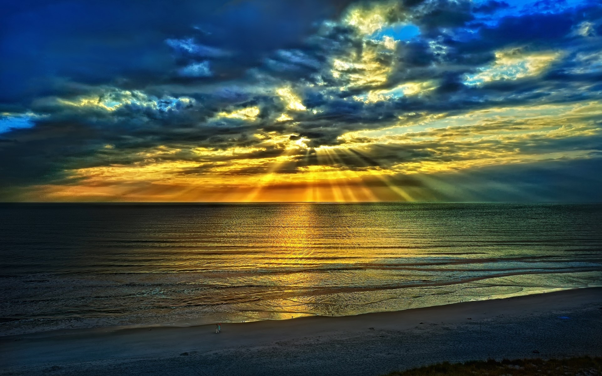 Sunbeams breaking through dark clouds over the ocean HD Wallpaper