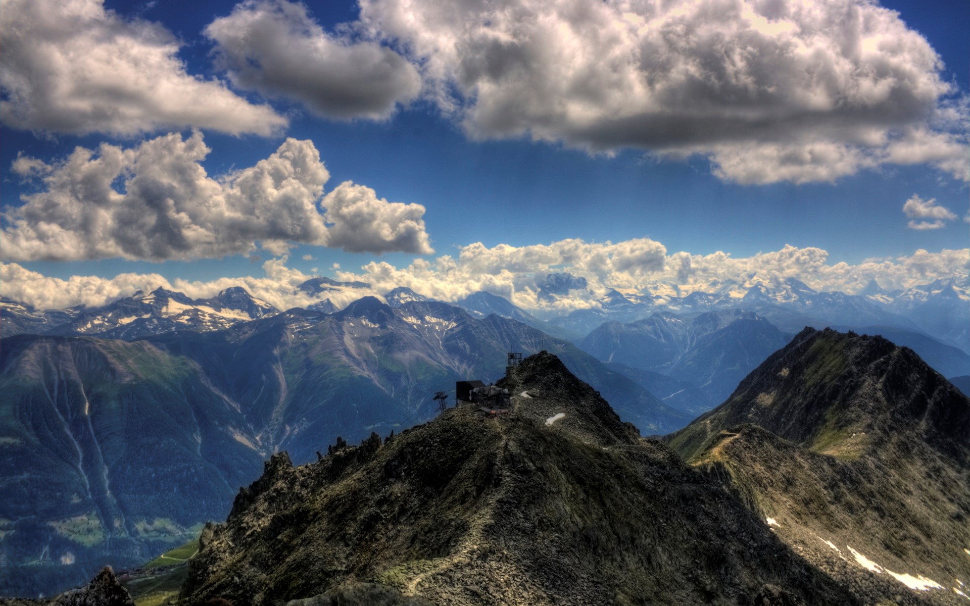 Mountain range with cable car station on peak HD Wallpaper