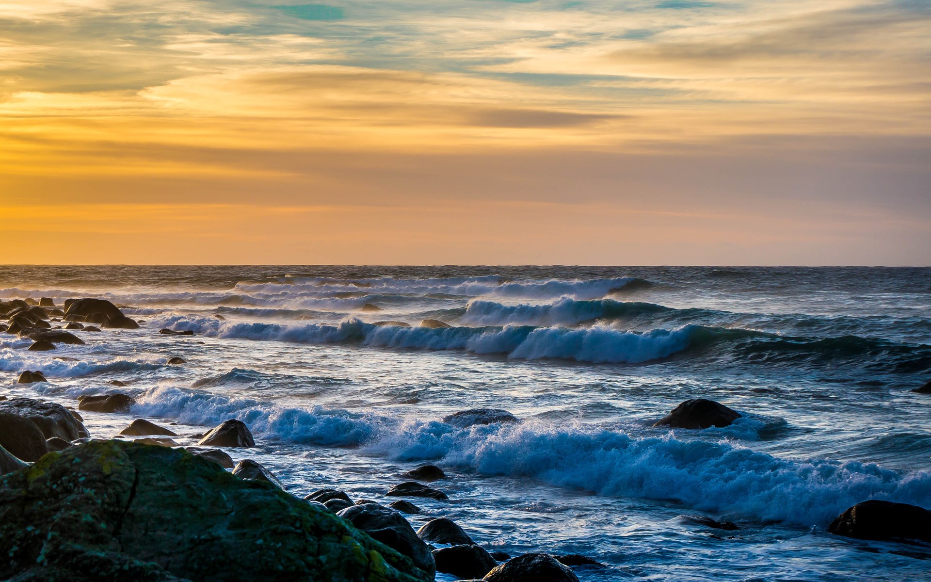 Waves crashing on a rocky shore at sunset HD Wallpaper