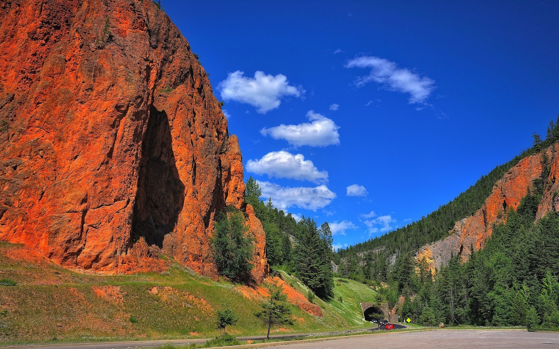 Red rock canyon with a tunnel and trees HD Wallpaper