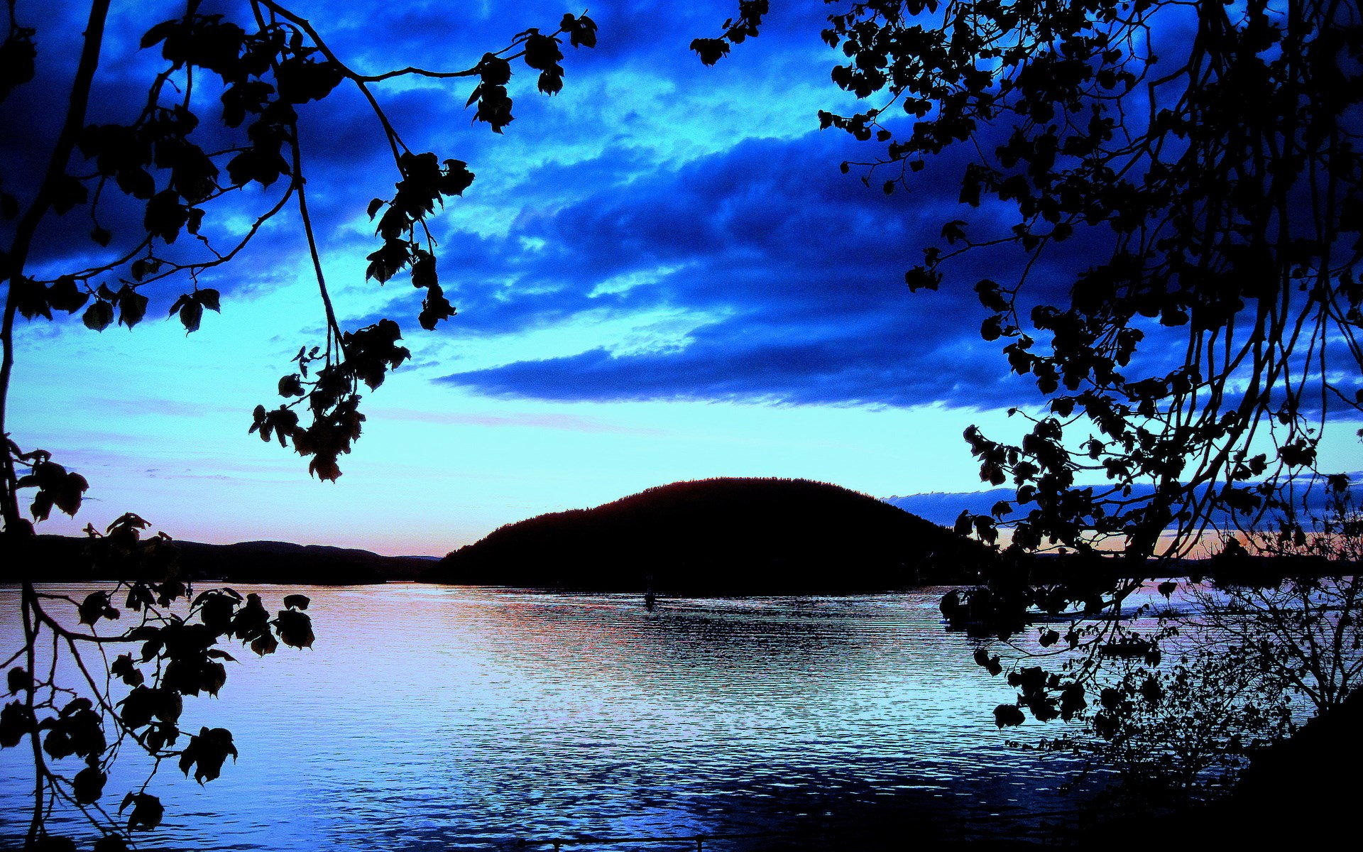 Silhouette of trees framing a lake at dusk HD Wallpaper