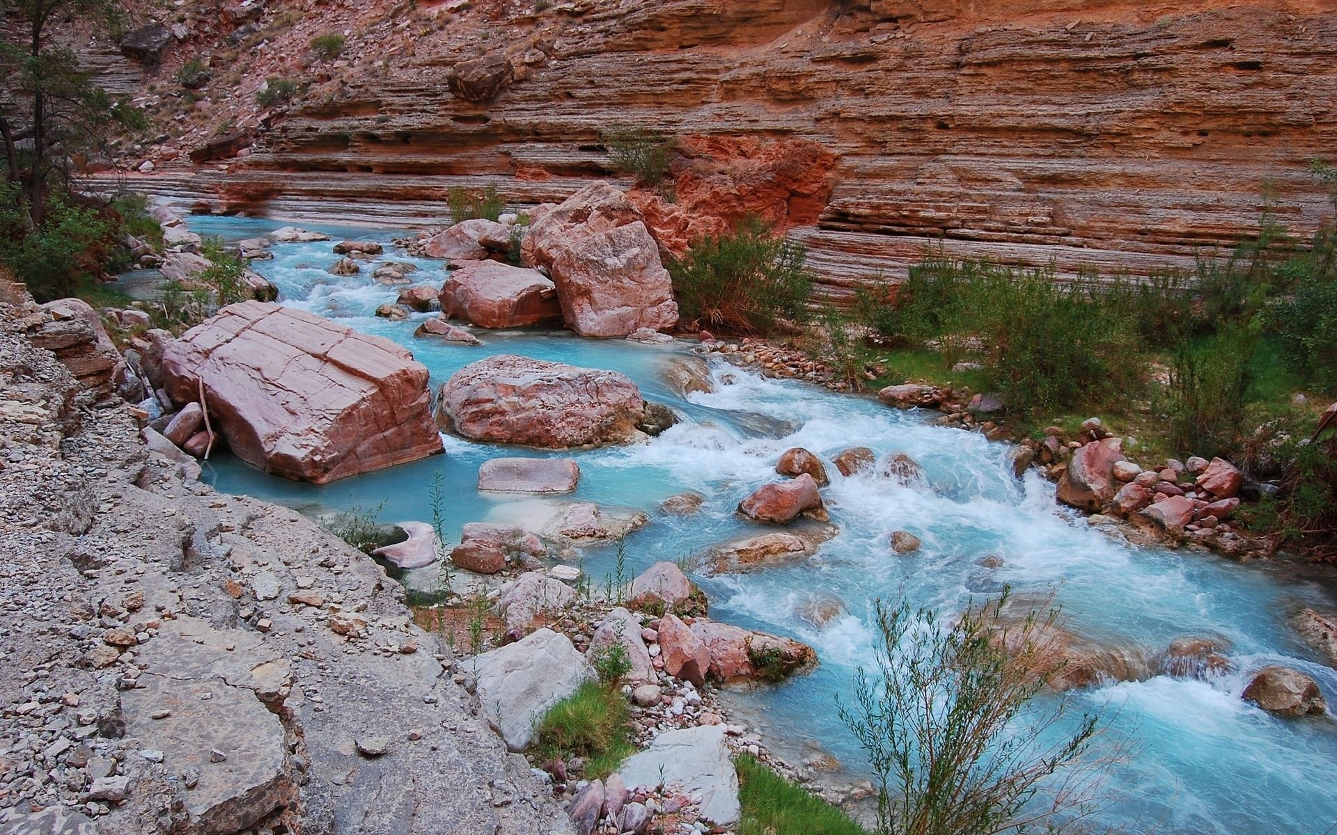Turquoise river flowing through a rocky canyon HD Wallpaper