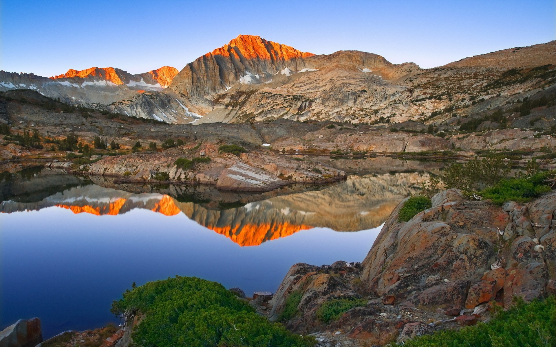 Mountain lake reflecting sunset on peaks HD Wallpaper