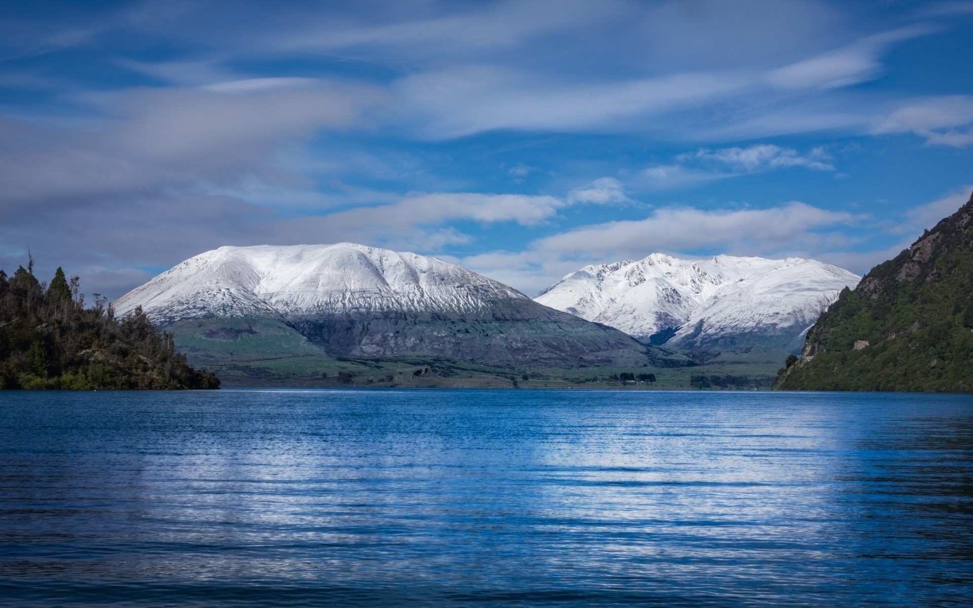 Snow-capped mountains reflected in a blue lake HD Wallpaper