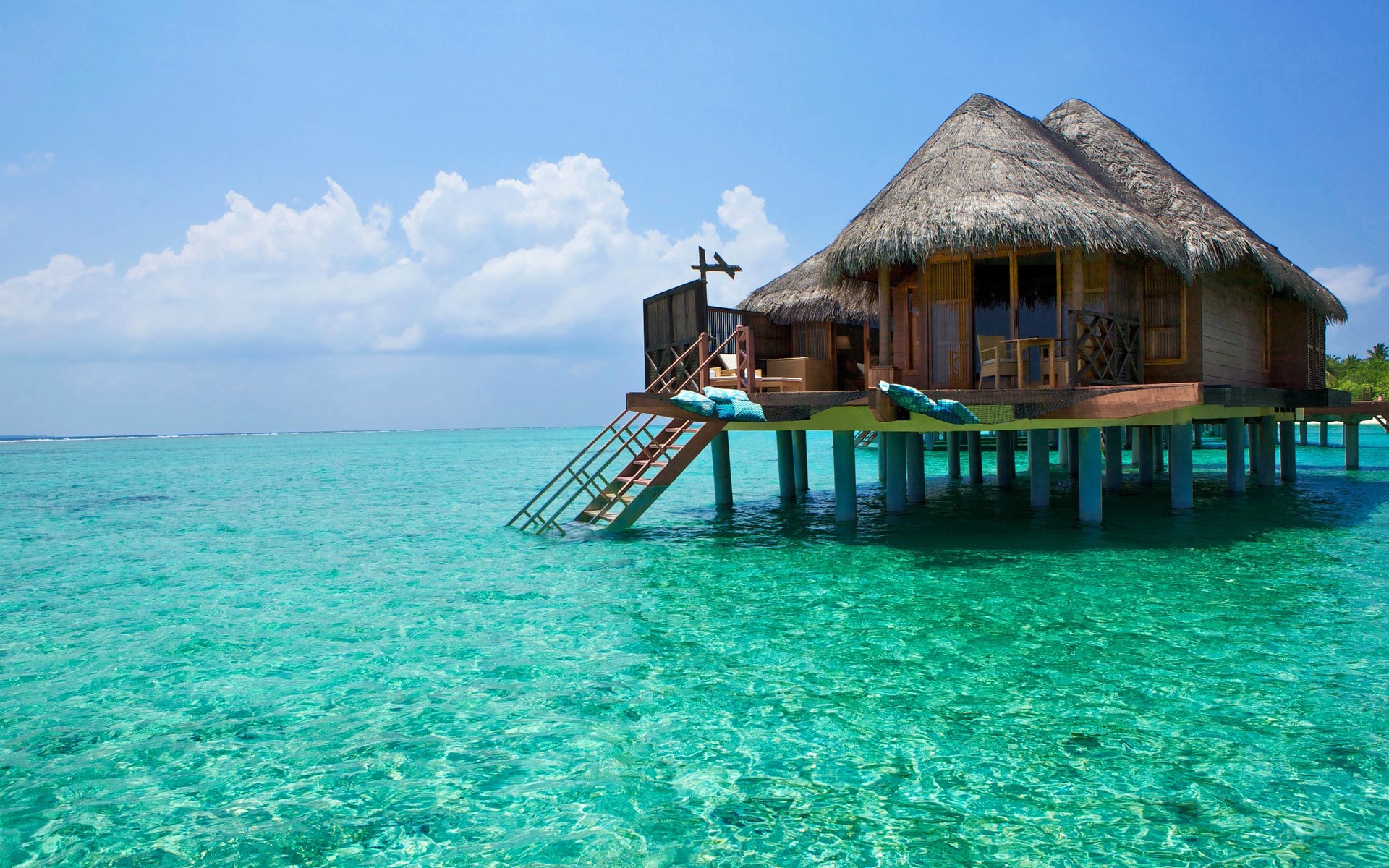 Overwater bungalow in turquoise ocean HD Wallpaper