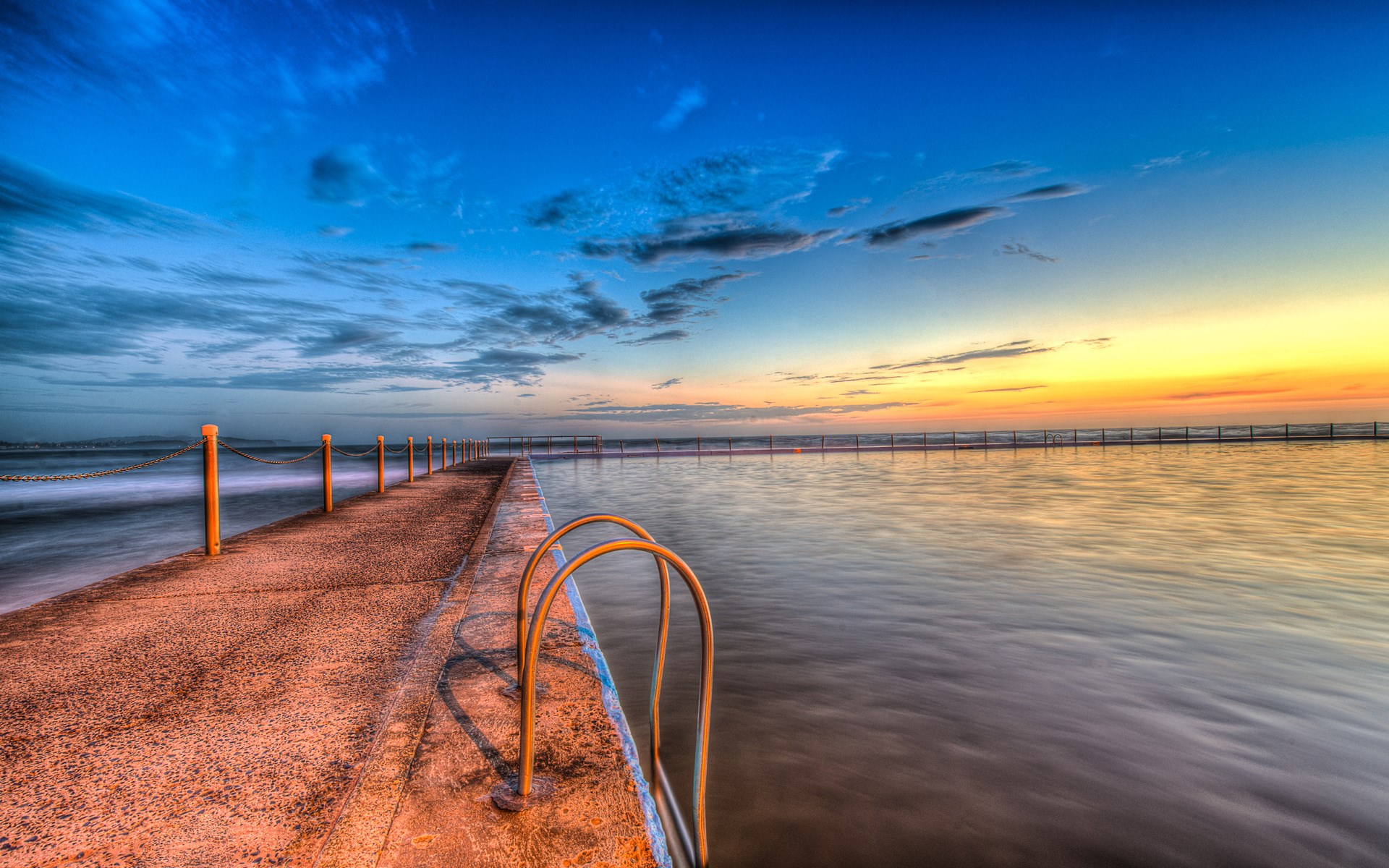 Ocean swimming pool at sunrise with calm water HD Wallpaper