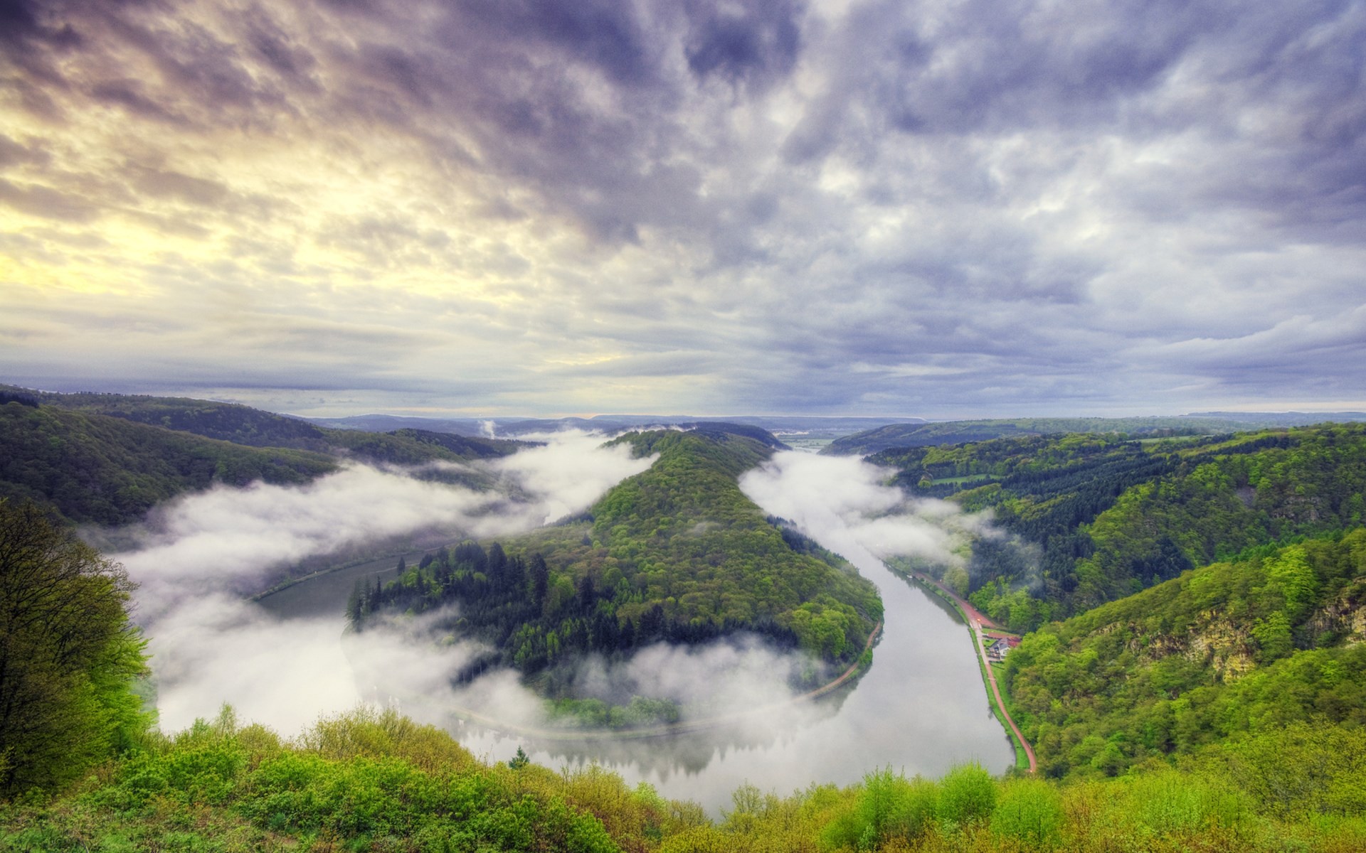 Misty river valley with green forested hills HD Wallpaper