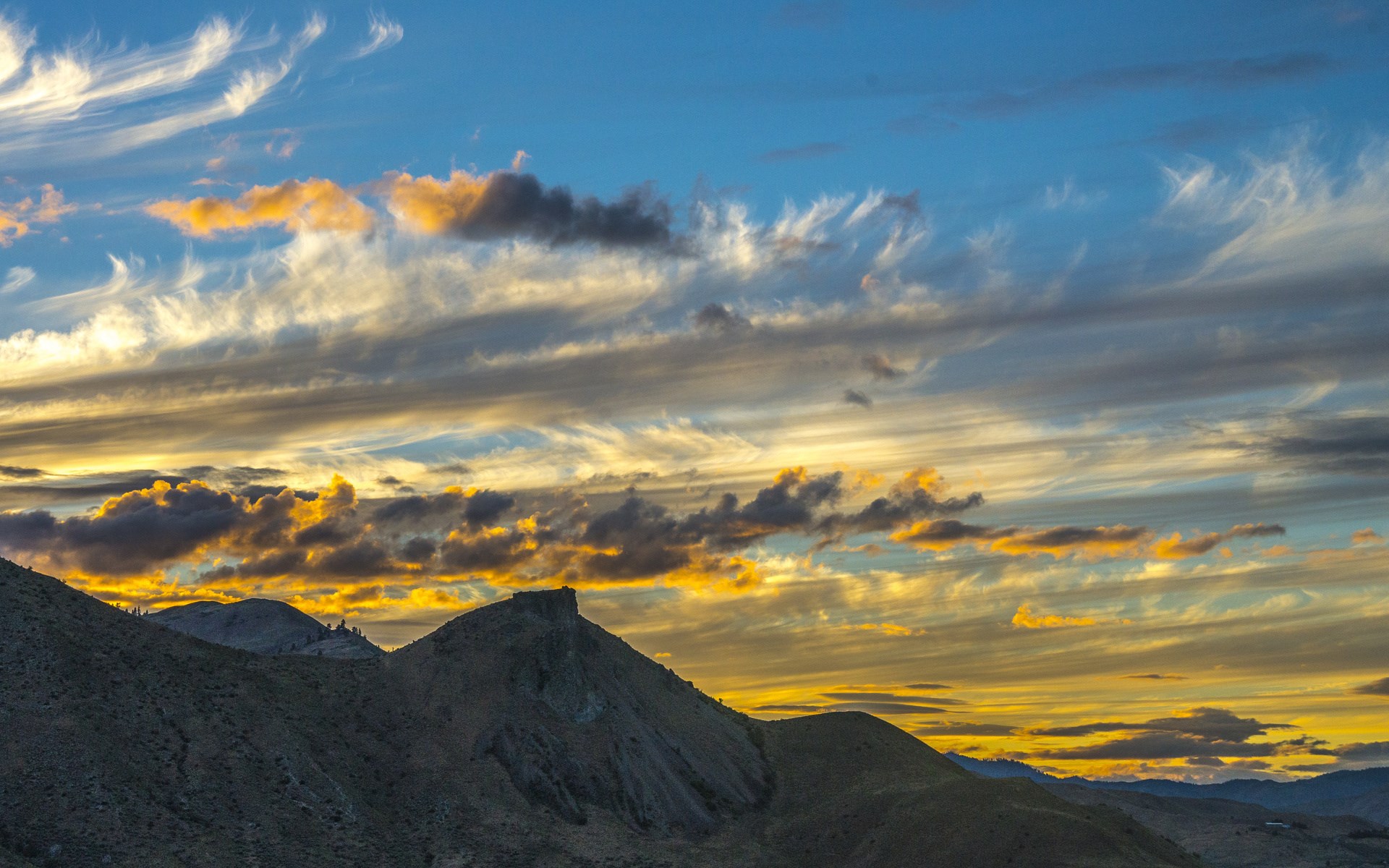 Sunset clouds over mountainous terrain HD Wallpaper