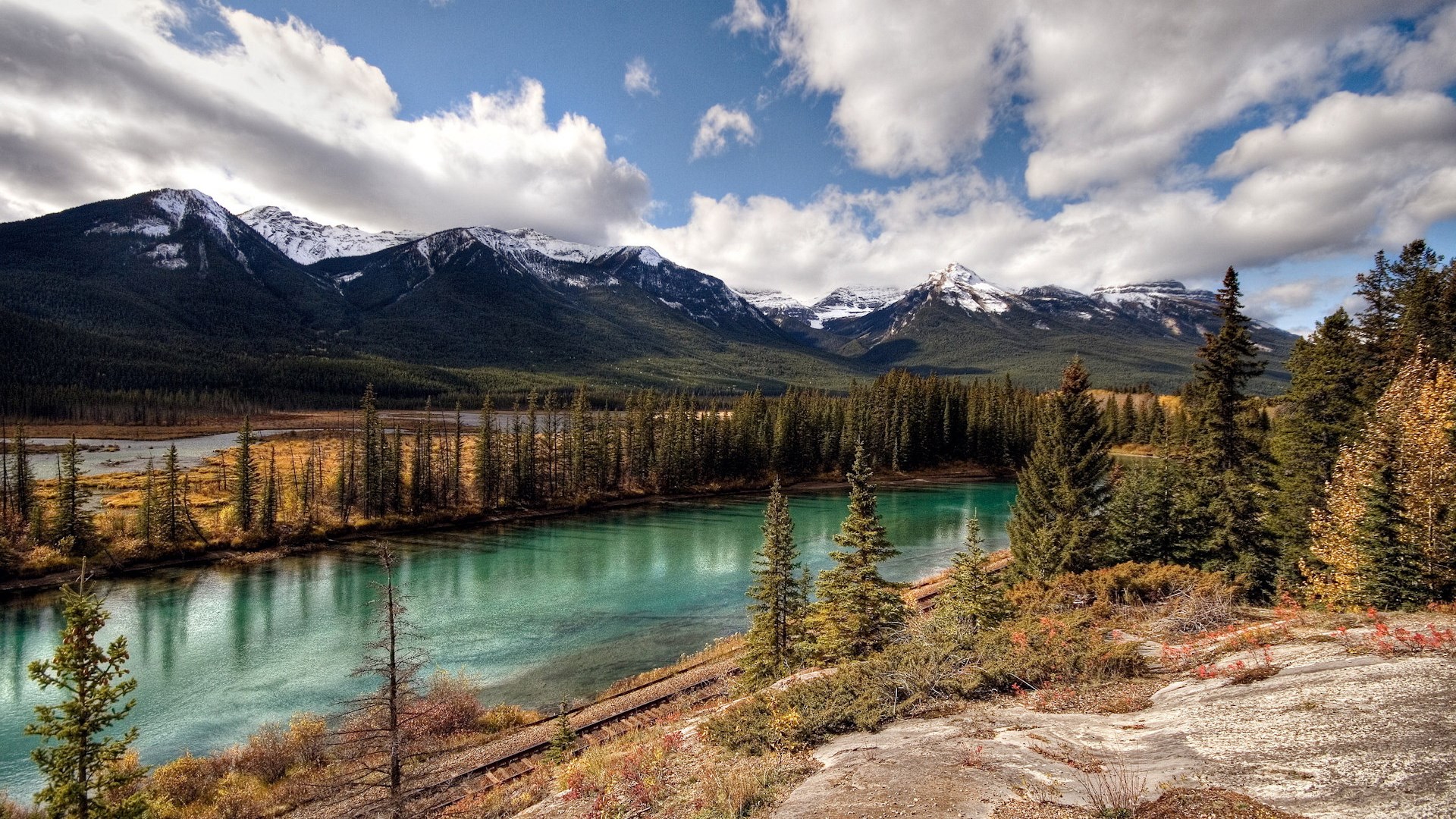 Turquoise river and snow-capped mountains in autumn HD Wallpaper