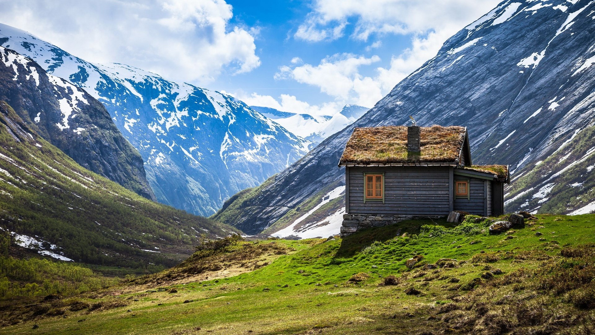 Wooden cabin with grass roof in a mountain valley HD Wallpaper