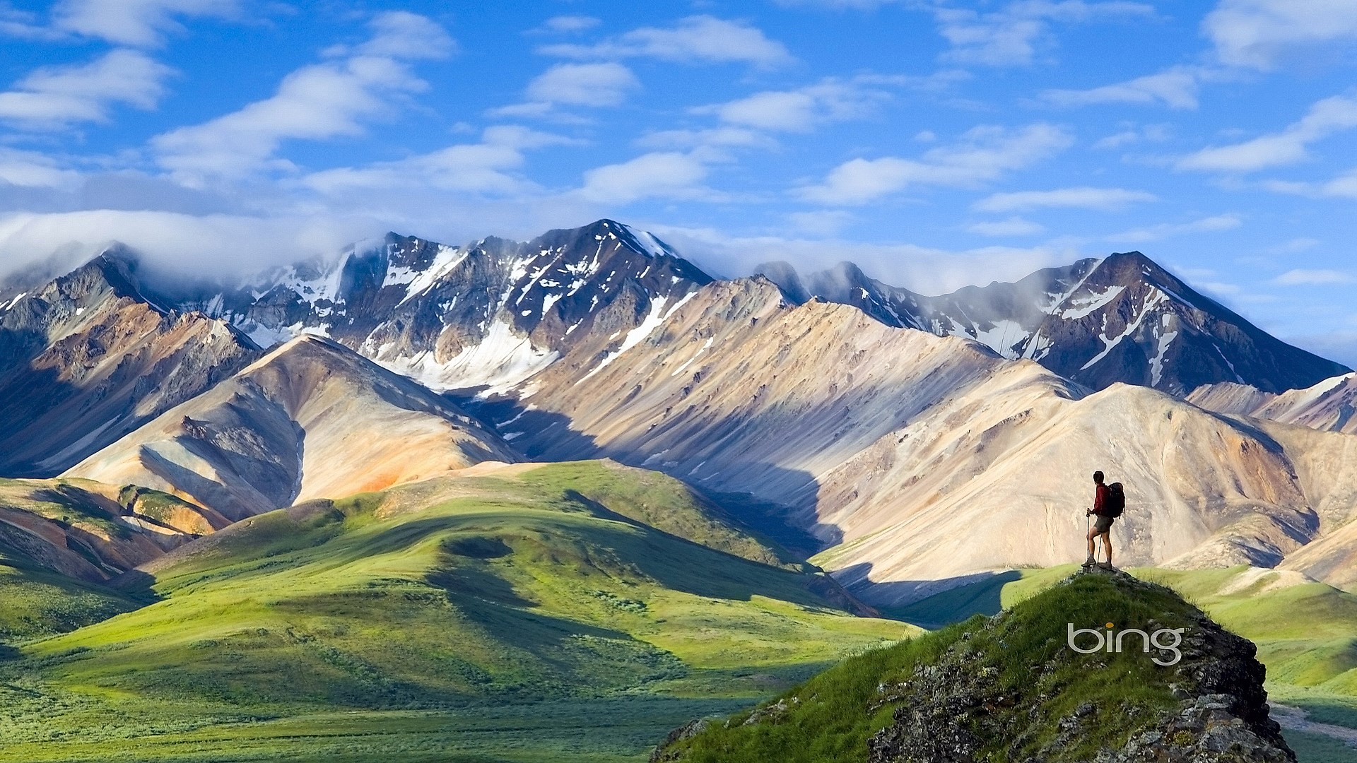 Hiker on a mountain peak with Bing logo HD Wallpaper