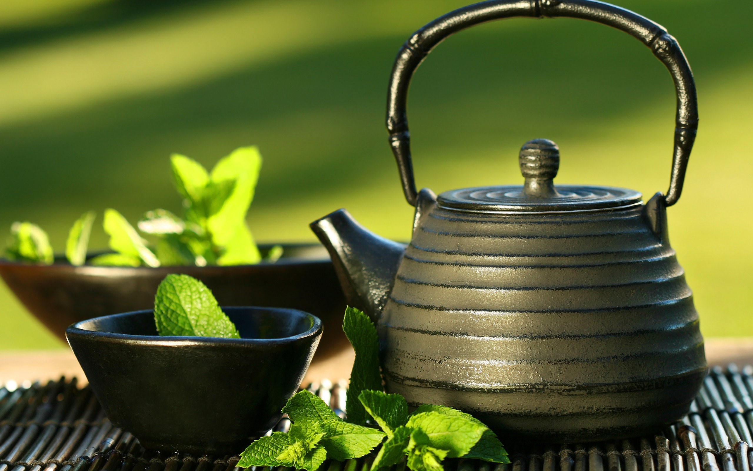Black cast iron teapot with mint leaves HD Wallpaper