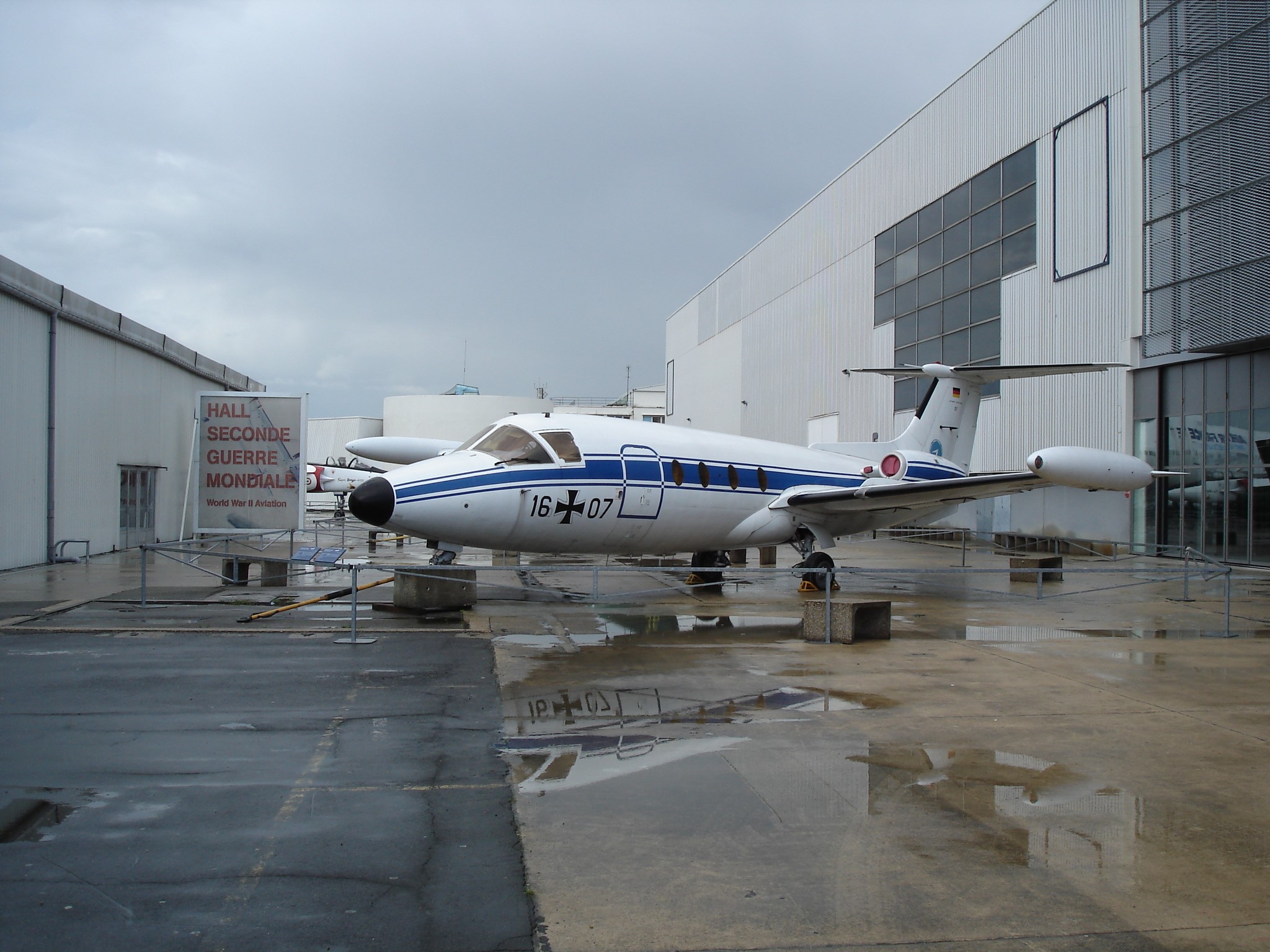 German military jet parked outside a hangar HD Wallpaper
