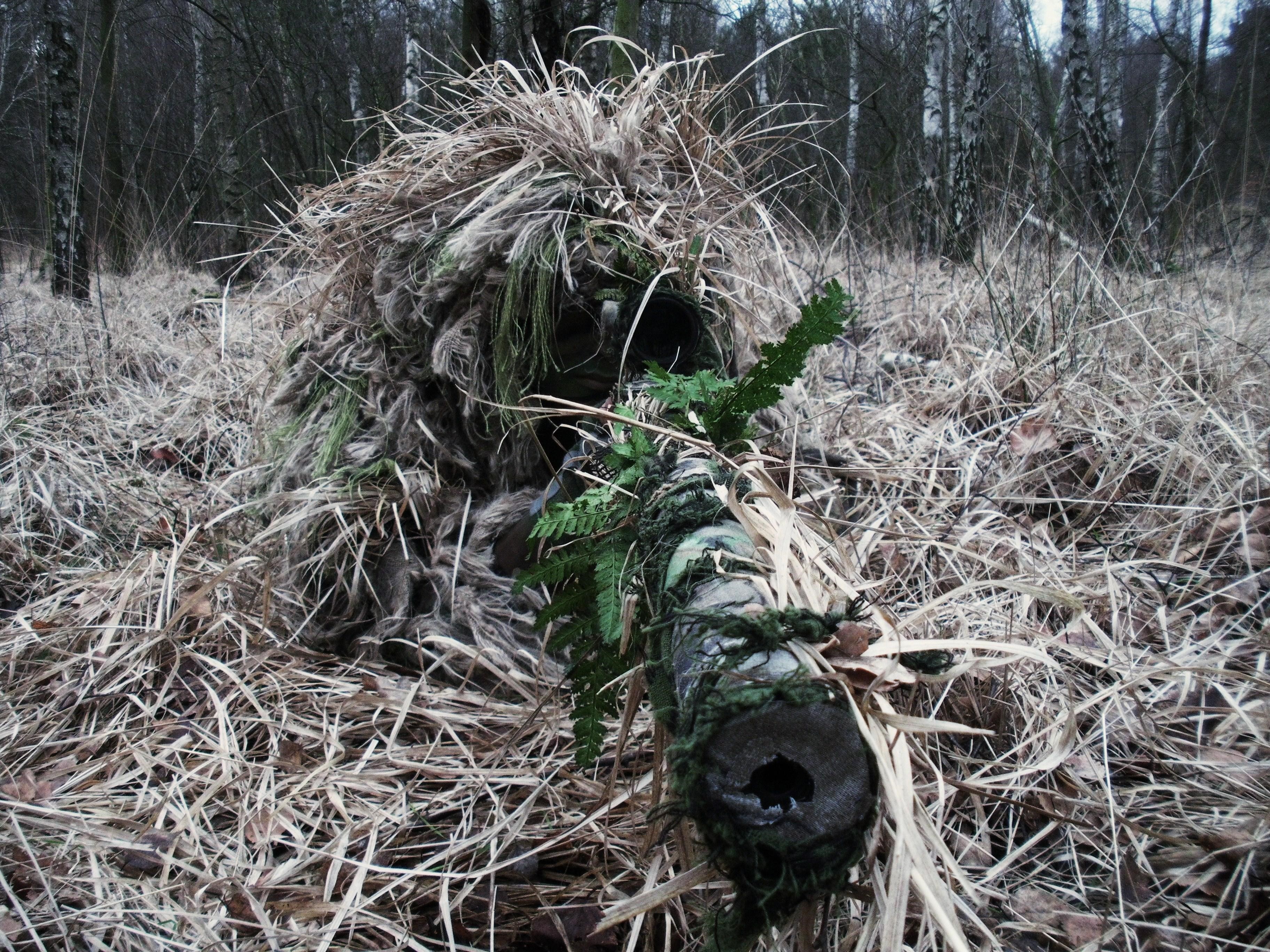 Soldier in ghillie suit with sniper rifle in forest HD Wallpaper
