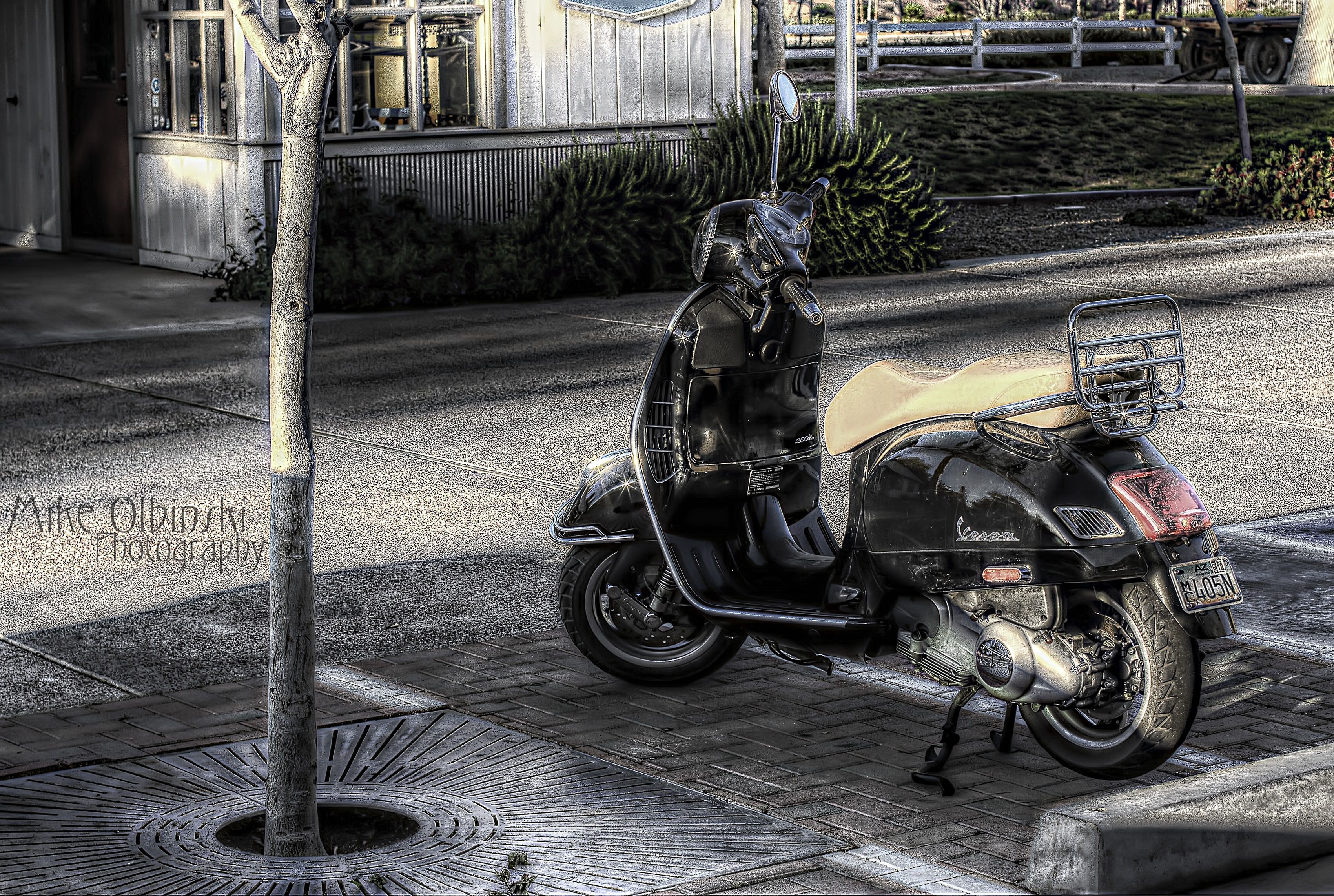 Black Vespa Scooter on Sidewalk HD Wallpaper