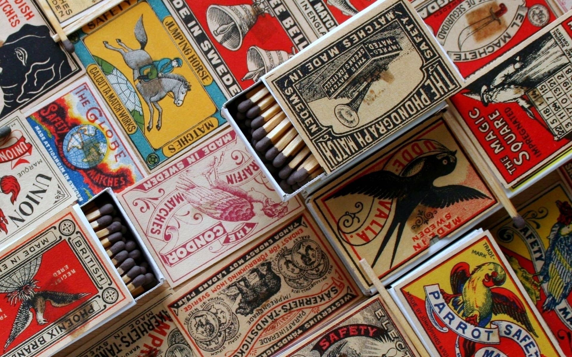 Collection of vintage matchboxes with various illustrations HD Wallpaper