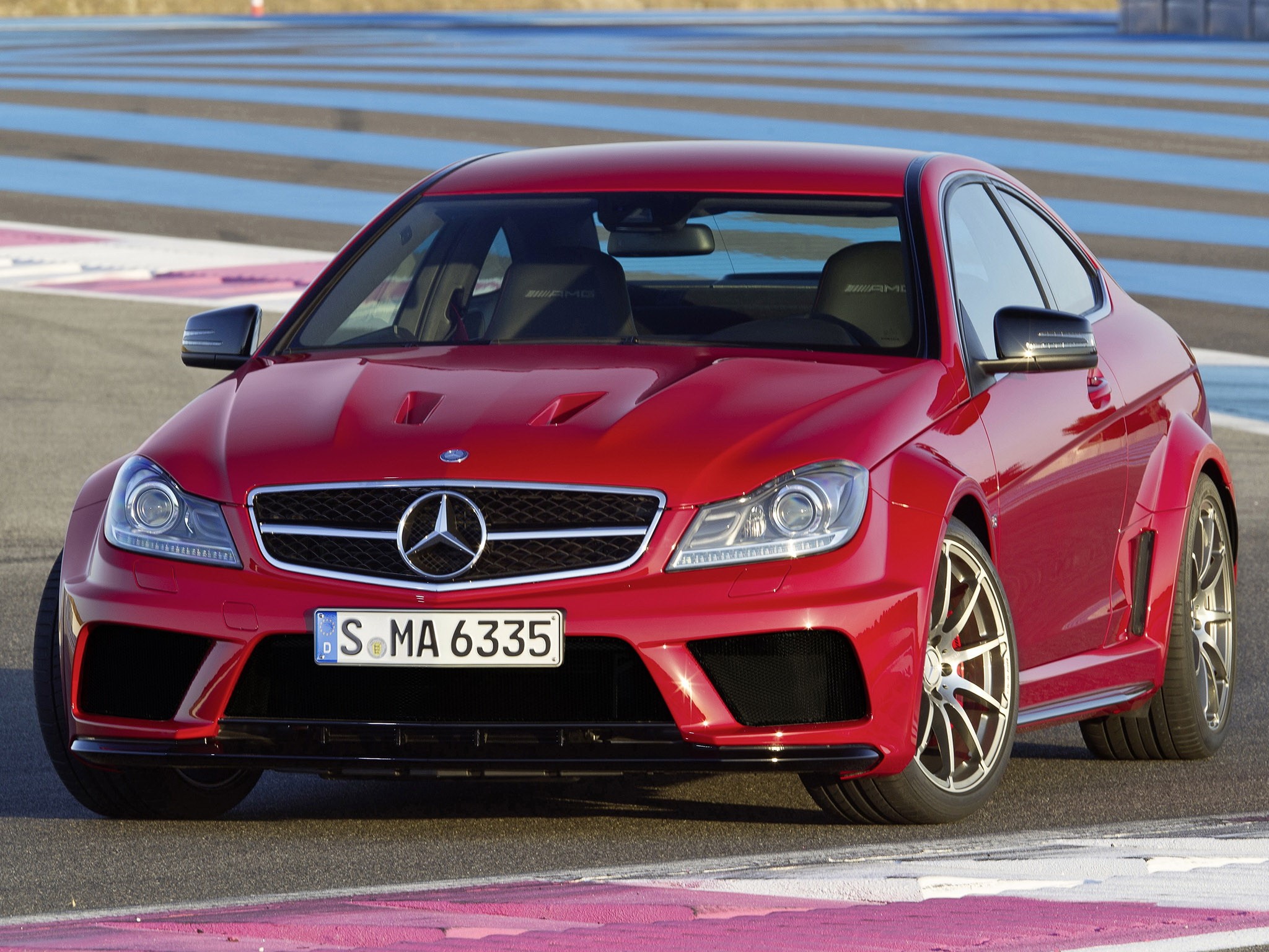 Red Mercedes-Benz C63 AMG Coupe on a Racetrack HD Wallpaper